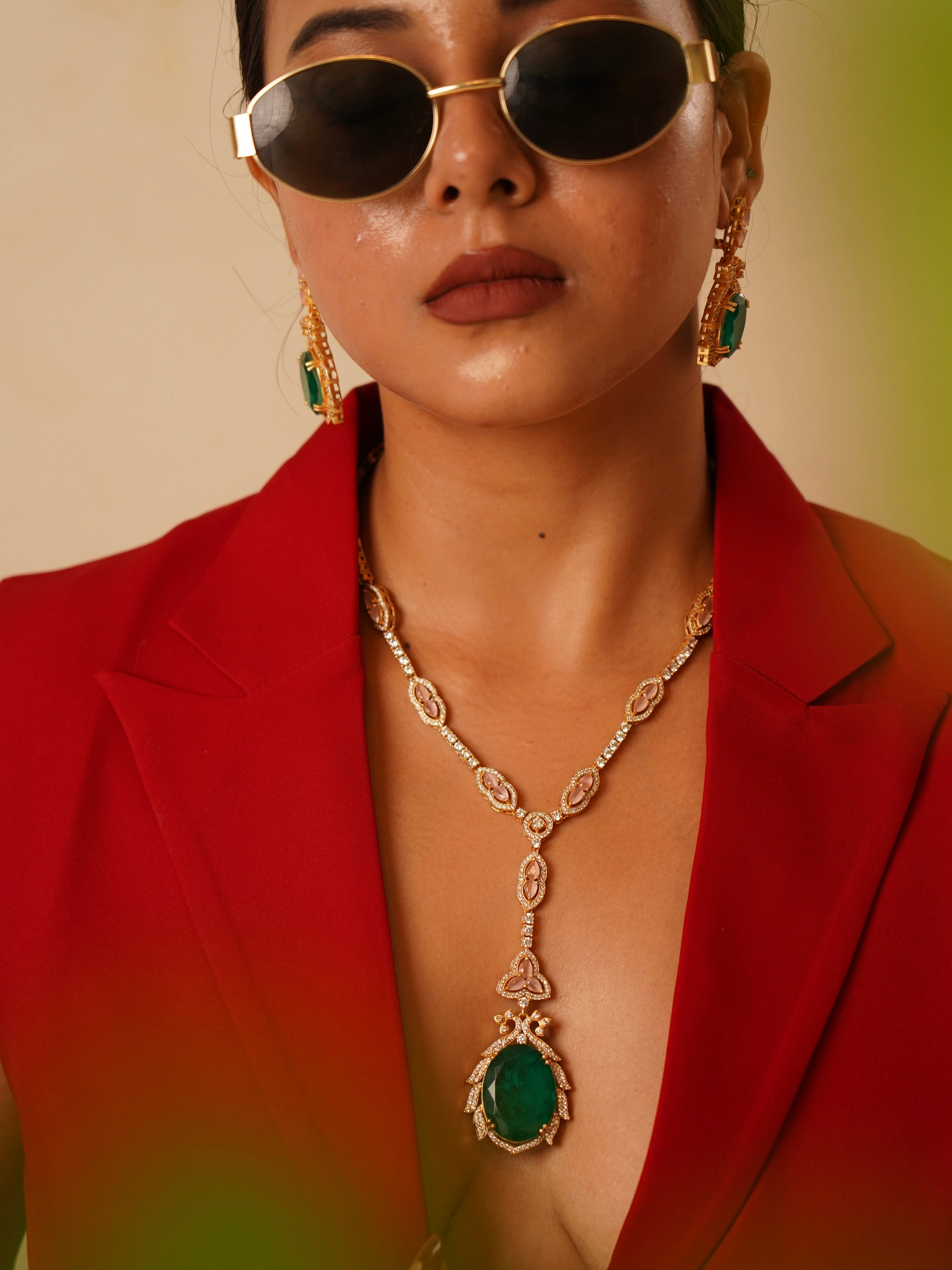 Statement necklace from the noorie set with crescent-shaped goldwork and red stone clusters