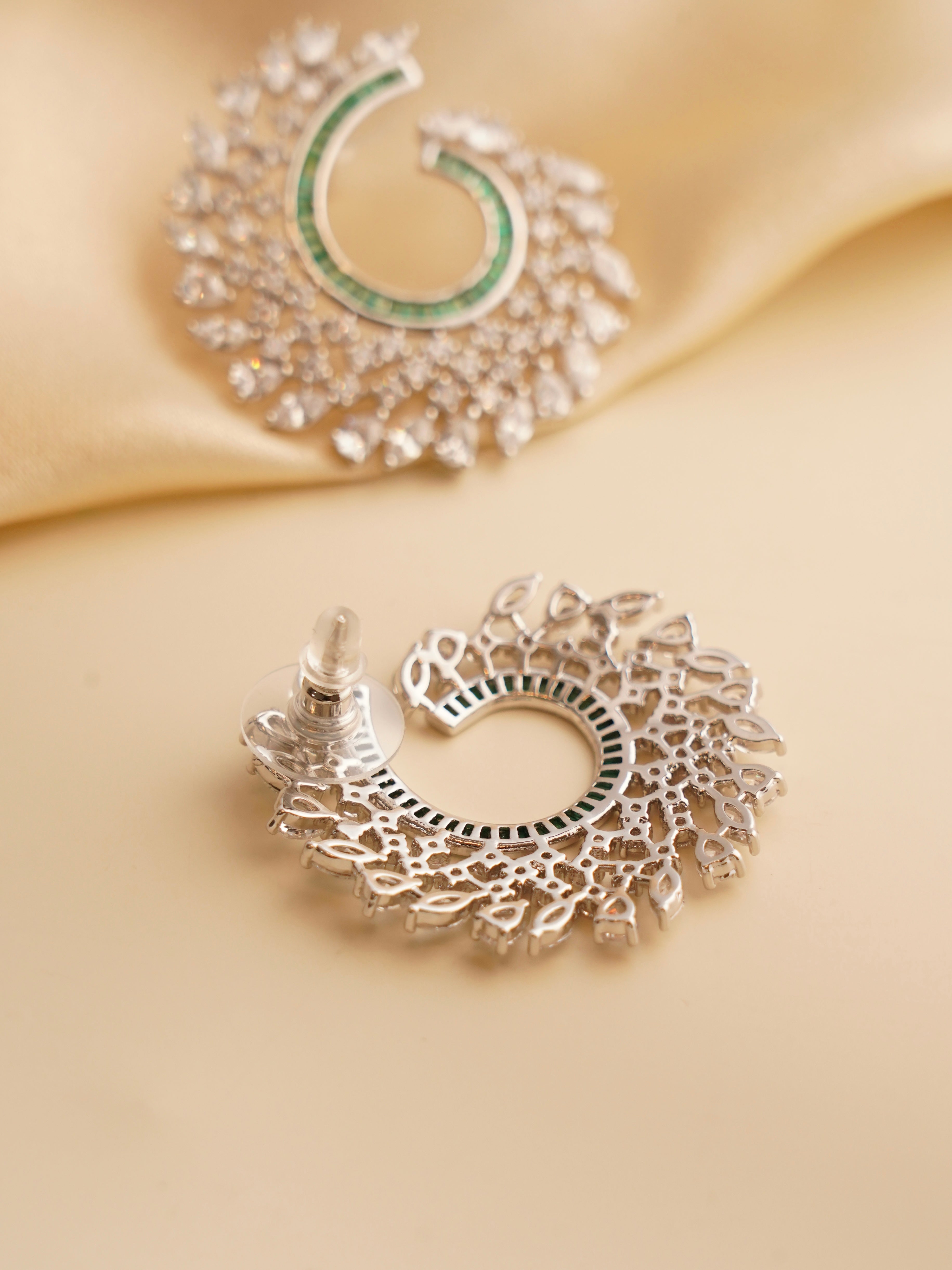 Angled shot showing the spiral shape and radiant jewel-toned baguette stones in polished setting