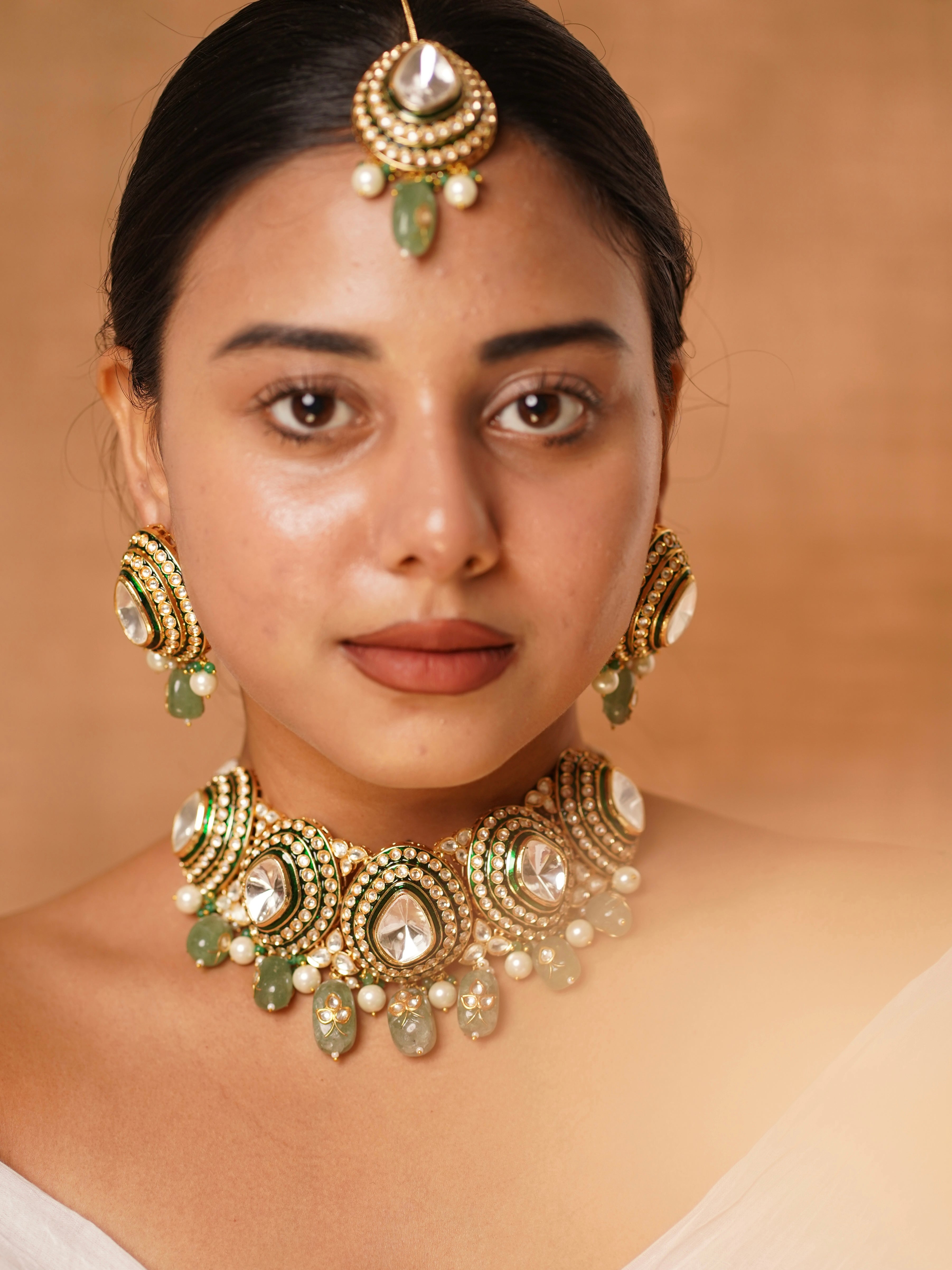 Uncut polki choker necklace with pearl and green bead drops in a bridal layered kundan frame