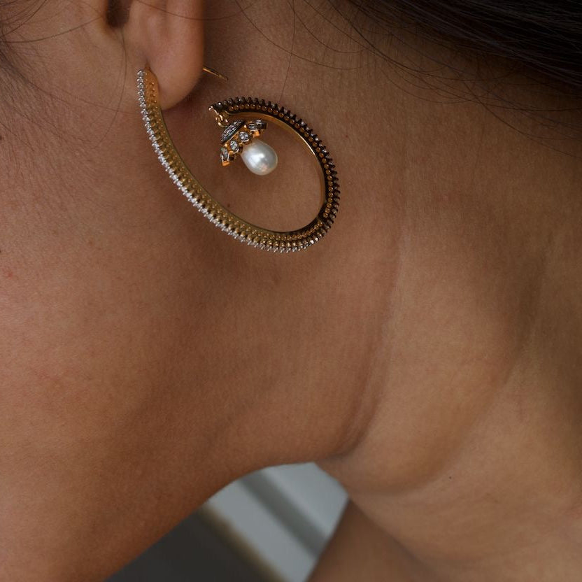 Elegant pearl drop hoop earrings with gold-toned finish in front view