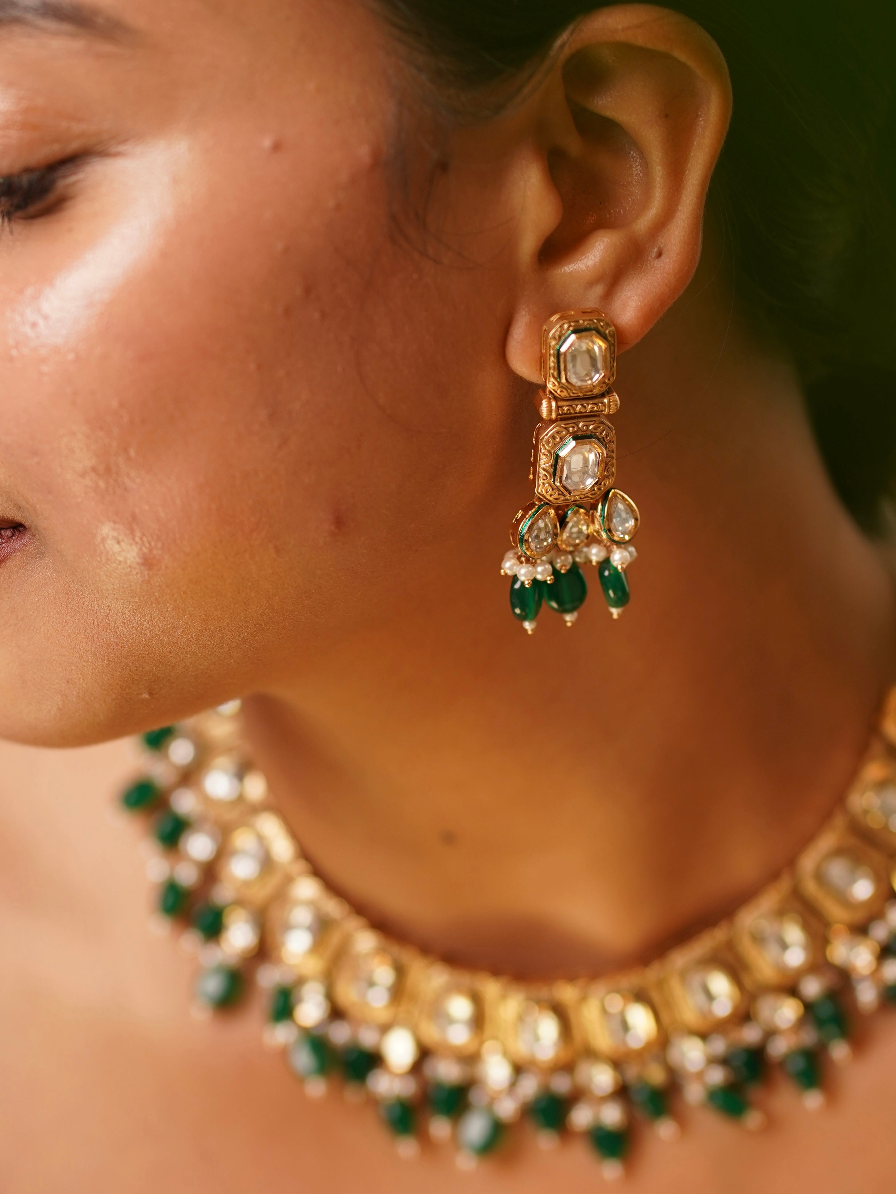 Close-up of Emera Kundan Royale earring showcasing uncut kundan stones, pearl accents and green drop beads