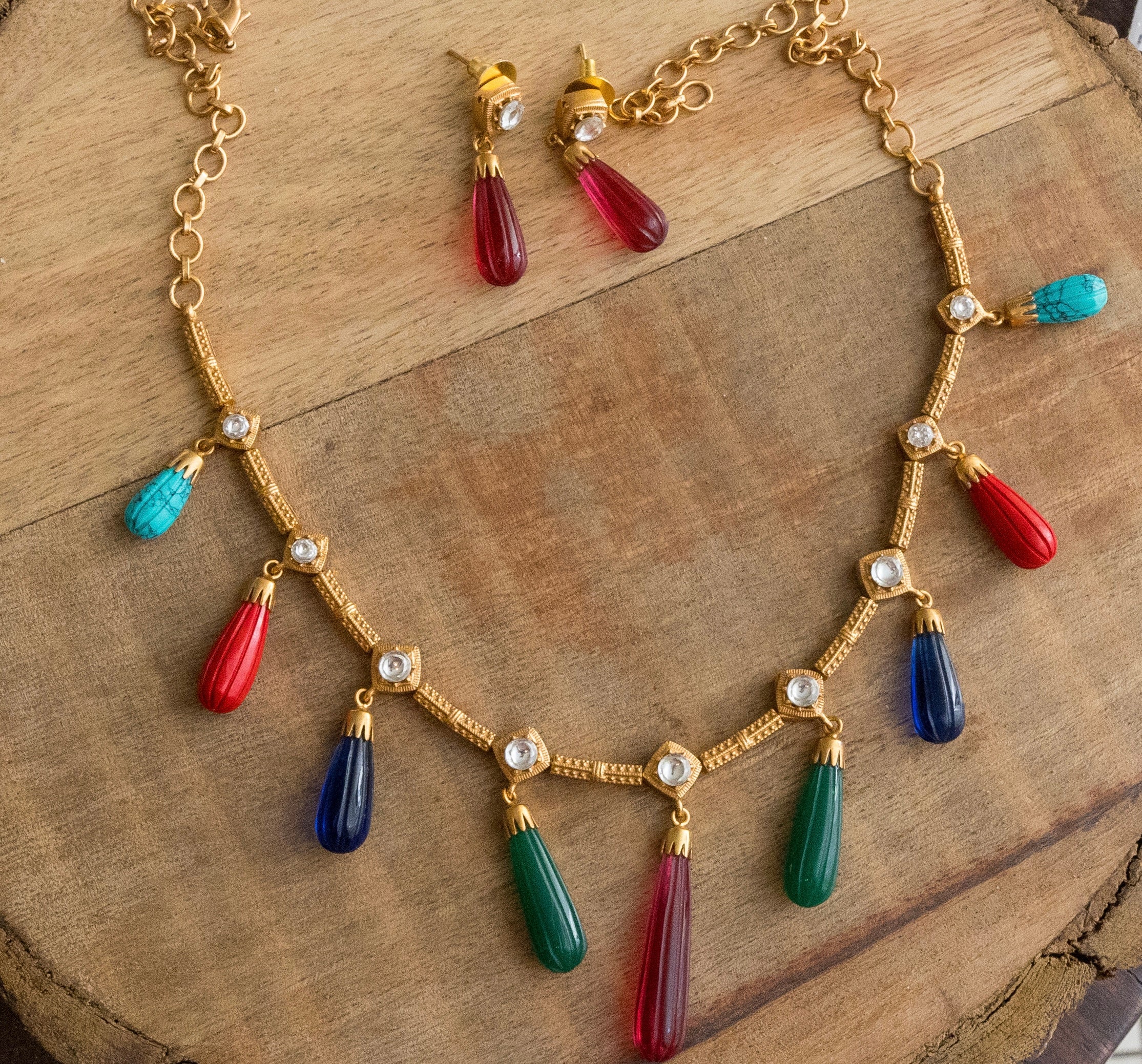 Full necklace set flat lay showing pendant, earrings, and matching design elements