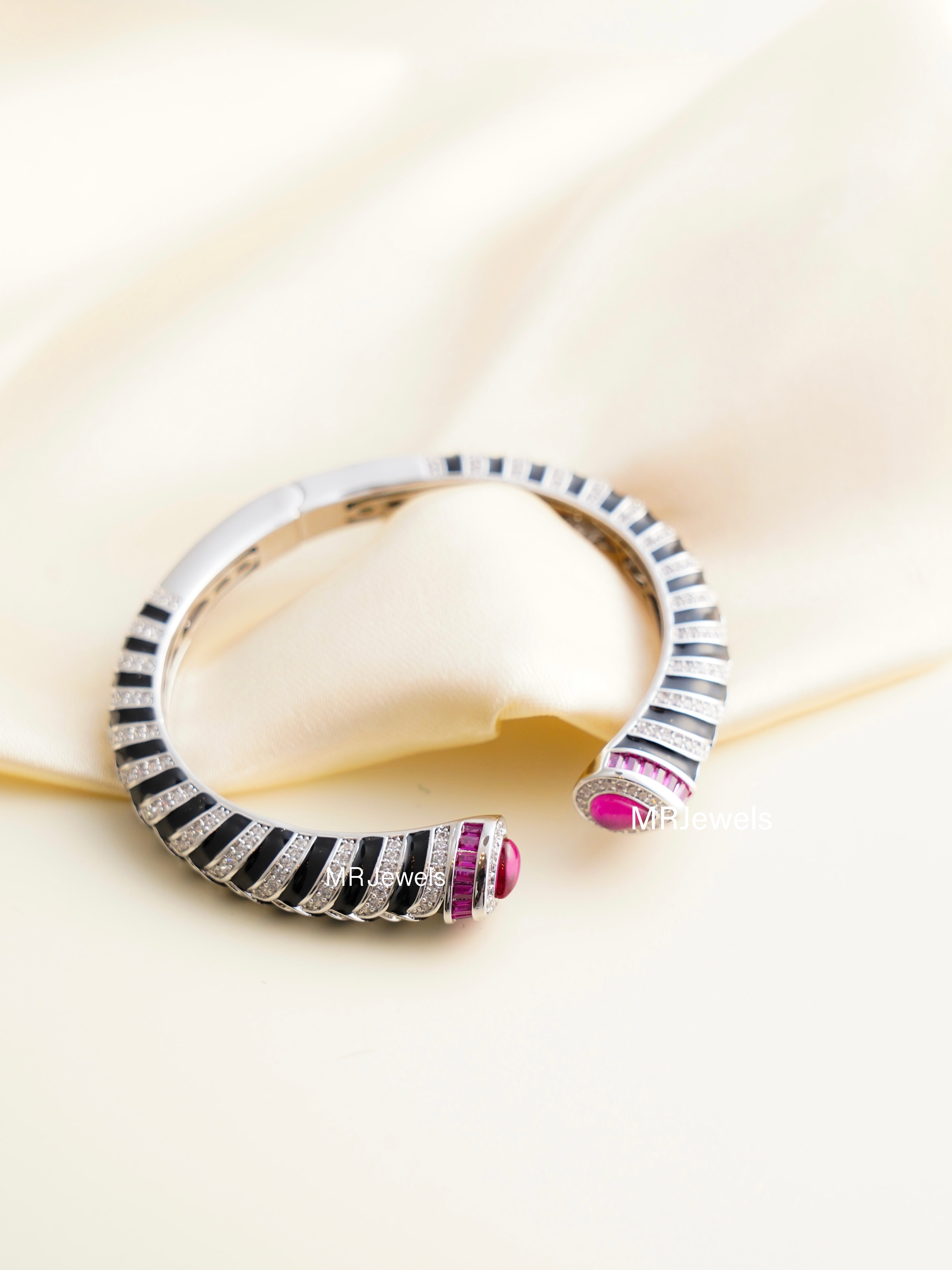 black enamel striped open cuff bracelet with ruby dome ends and sparkling cz detailing
