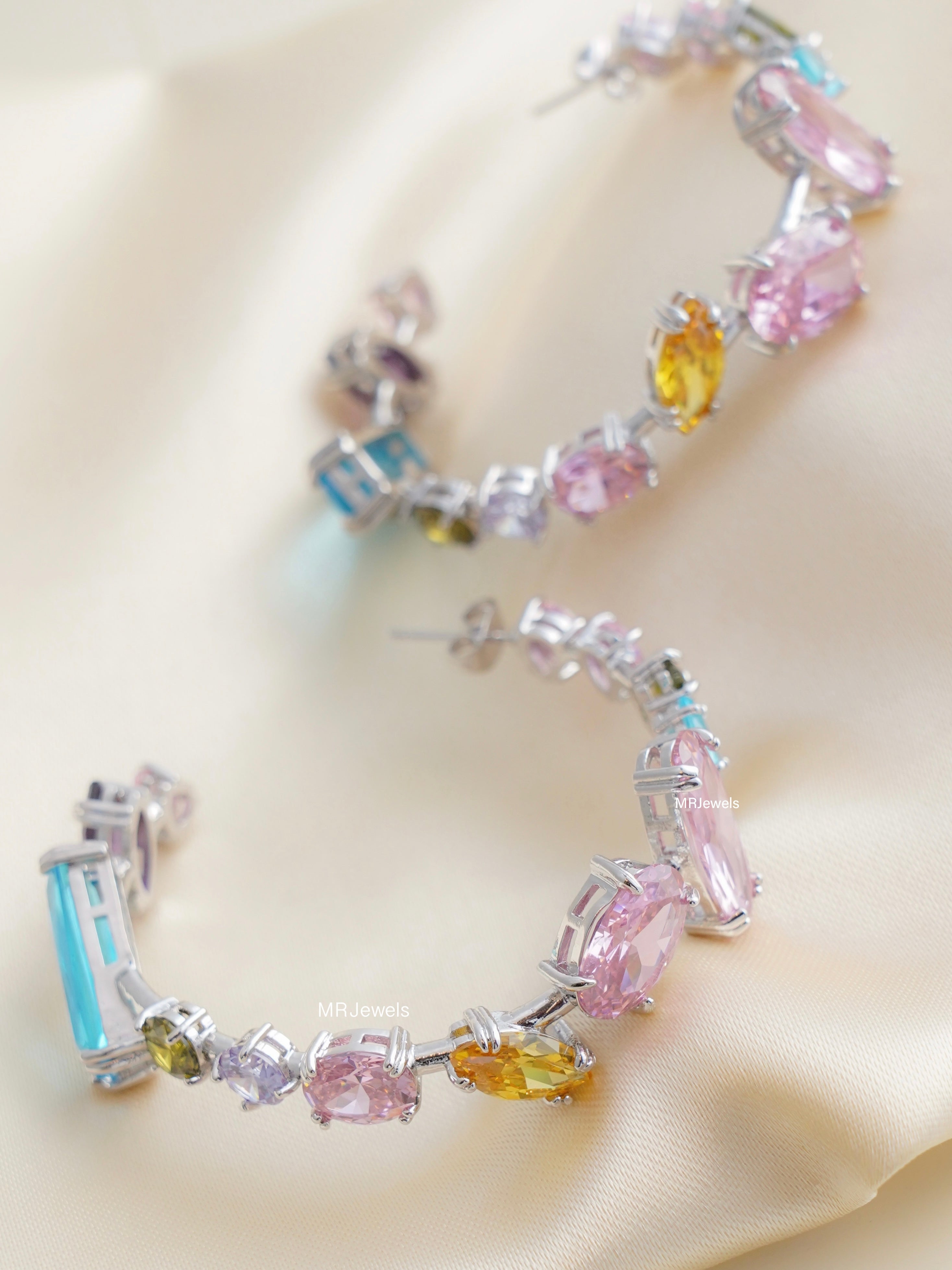 large hoop earrings paved with champagne swarovski crystals, front view on white background