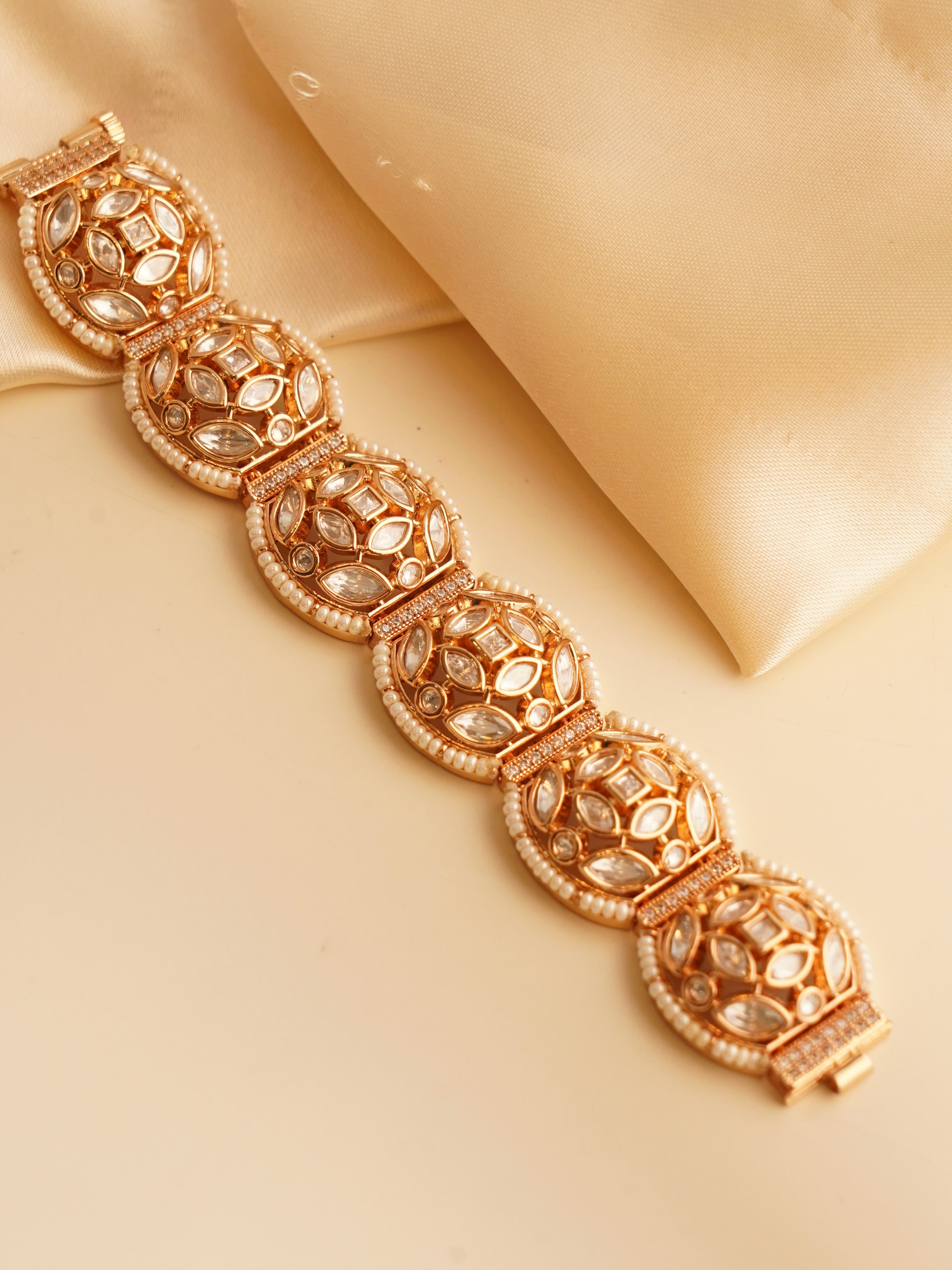 Kundan bracelet with gold patterns, pearl accents, and dazzling kundan stone detailing