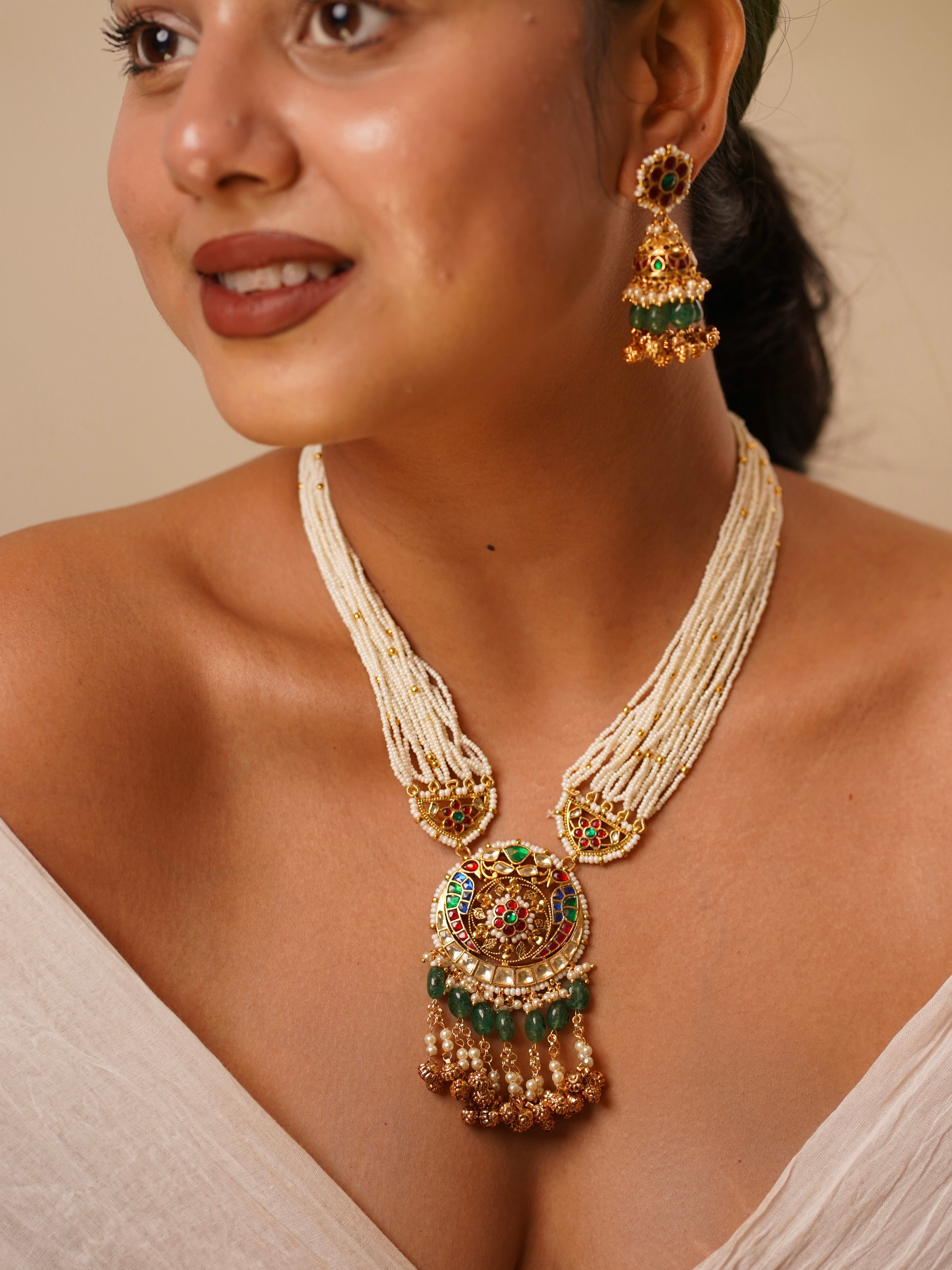 Angled close-up of kundan and pearl long necklace showing rich detailing