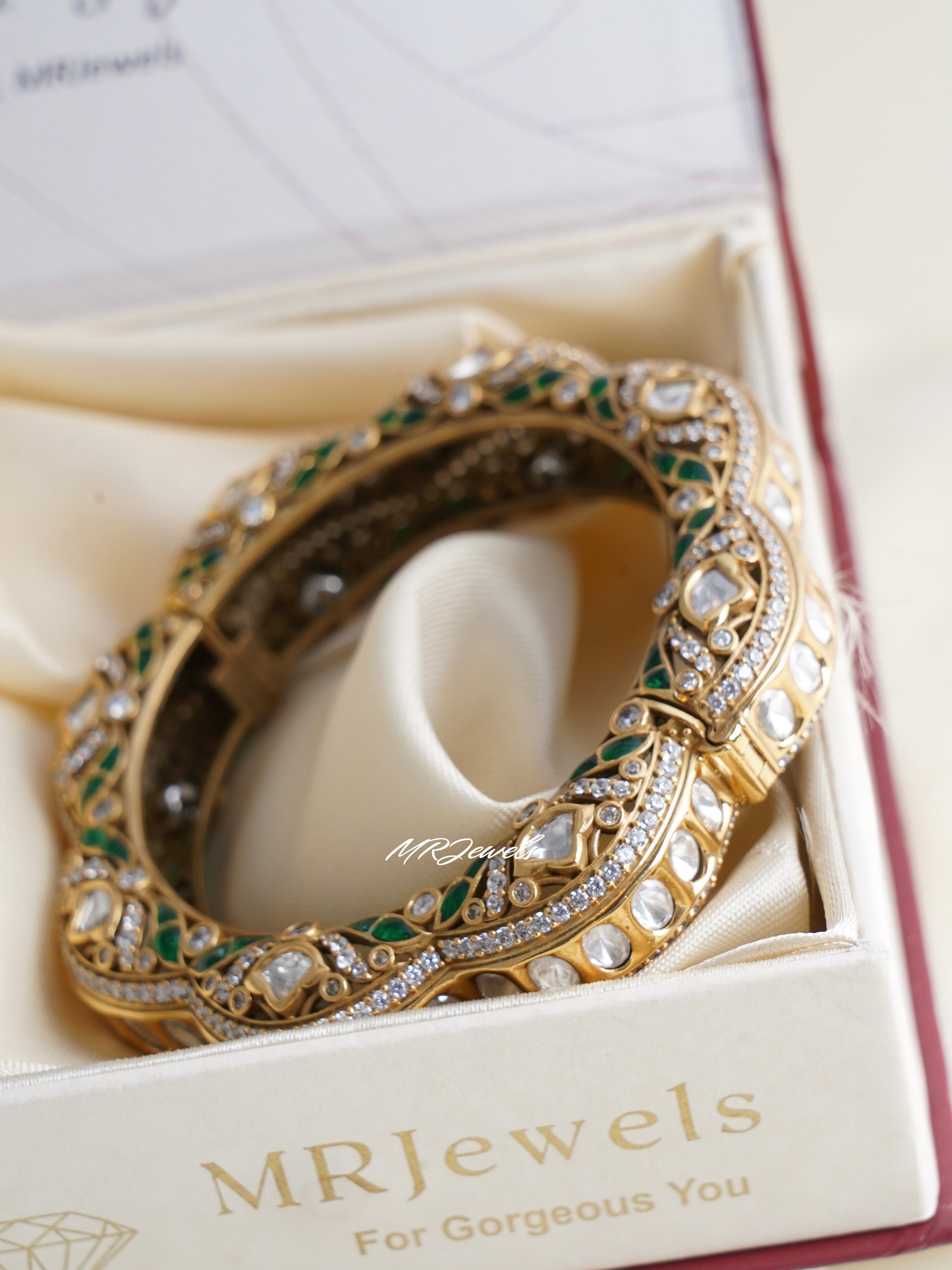 Side angle of designer kundan bangles with gold finish and embedded stones