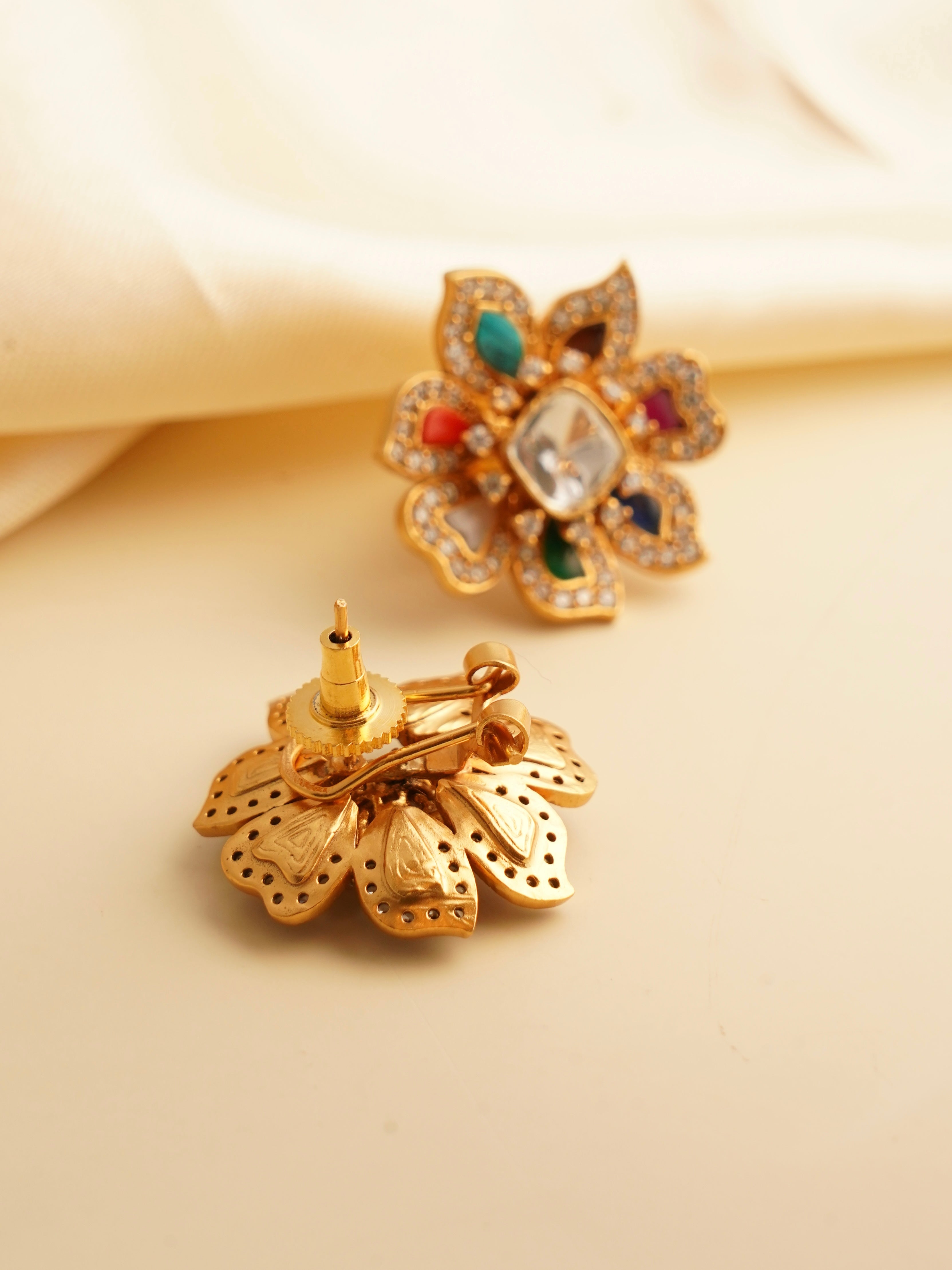 angled view of moissanite stud earrings with glossy mother-of-pearl centre