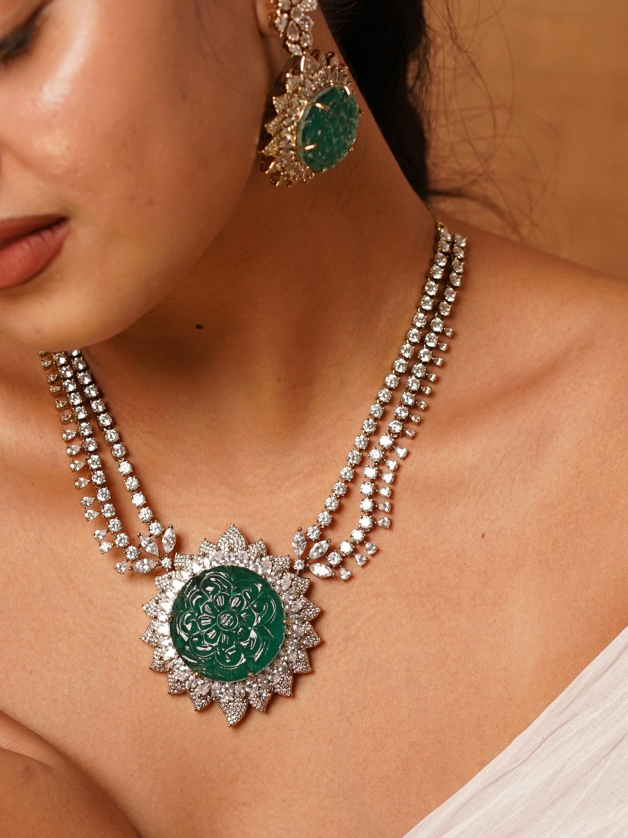 Necklace set with carved emerald medallion, CZ floral burst design and matching earrings and cuff