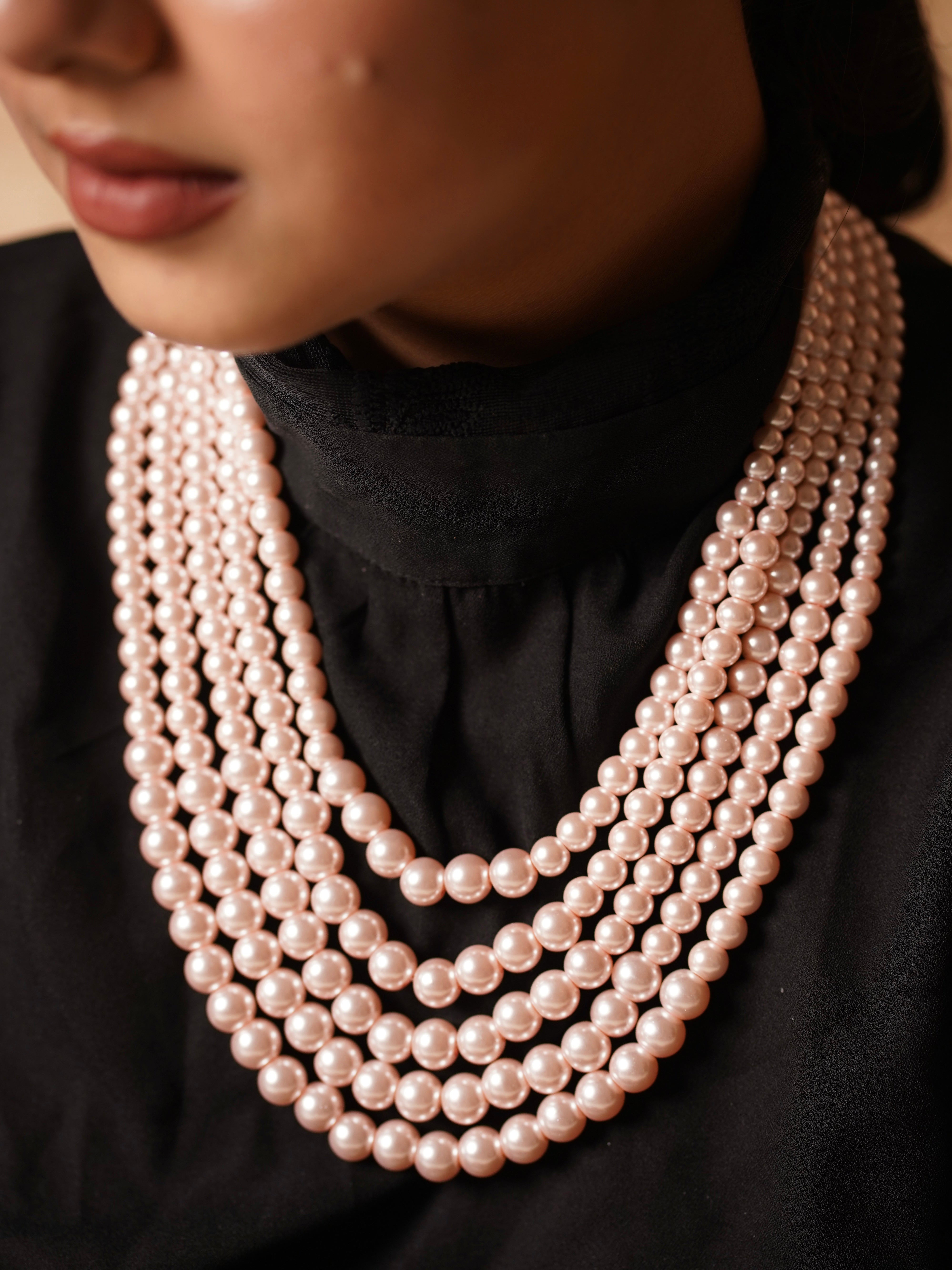 Overhead shot of five-layer pearl necklace laid flat to show arrangement