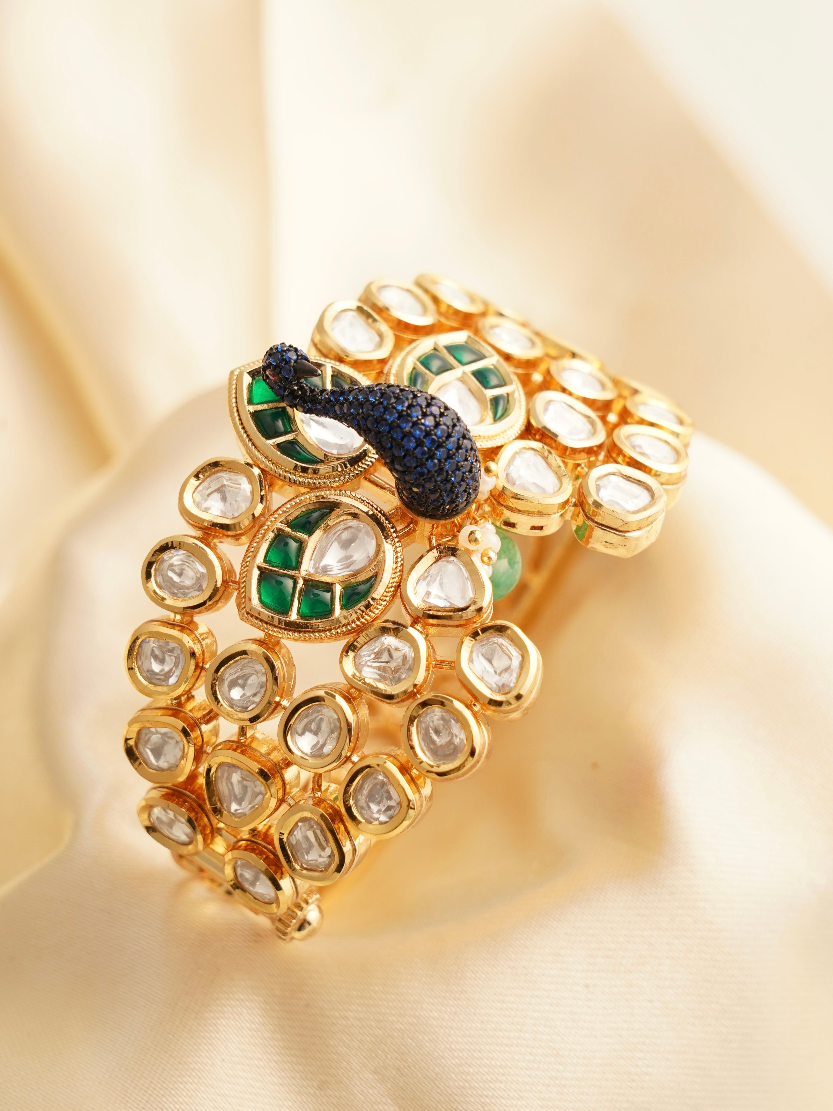 close-up of peacock bracelet design with elegant gold detailing and gemstone accents