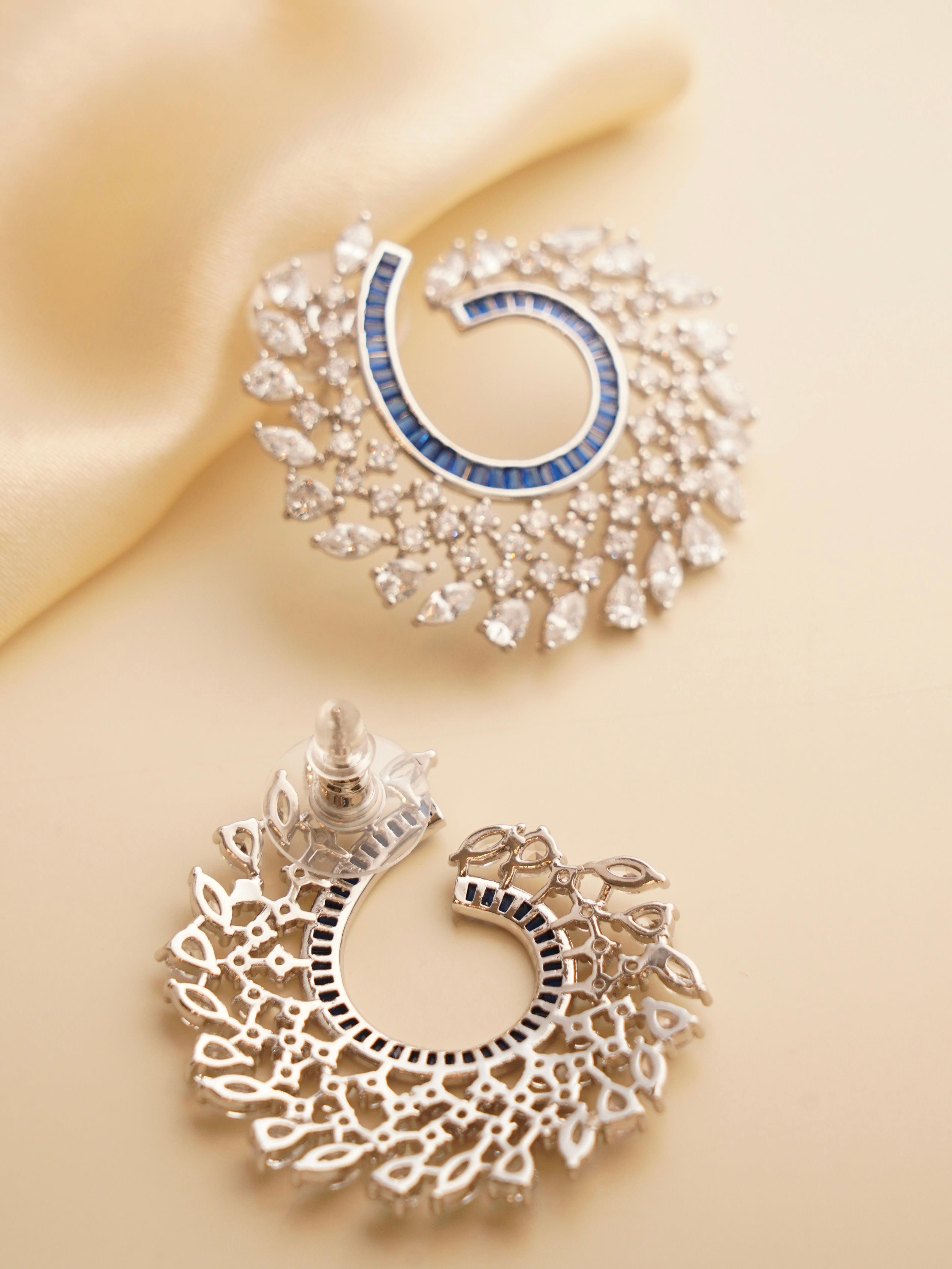 Side view of Celestia spiral earrings with layered baguette stones and twisted silhouette
