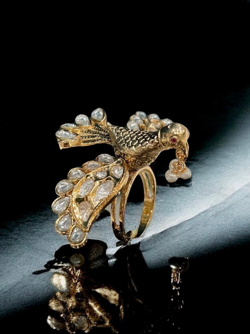 Detail shot of adjustable bird cocktail ring with multi-shade enamel and kundan centerpiece