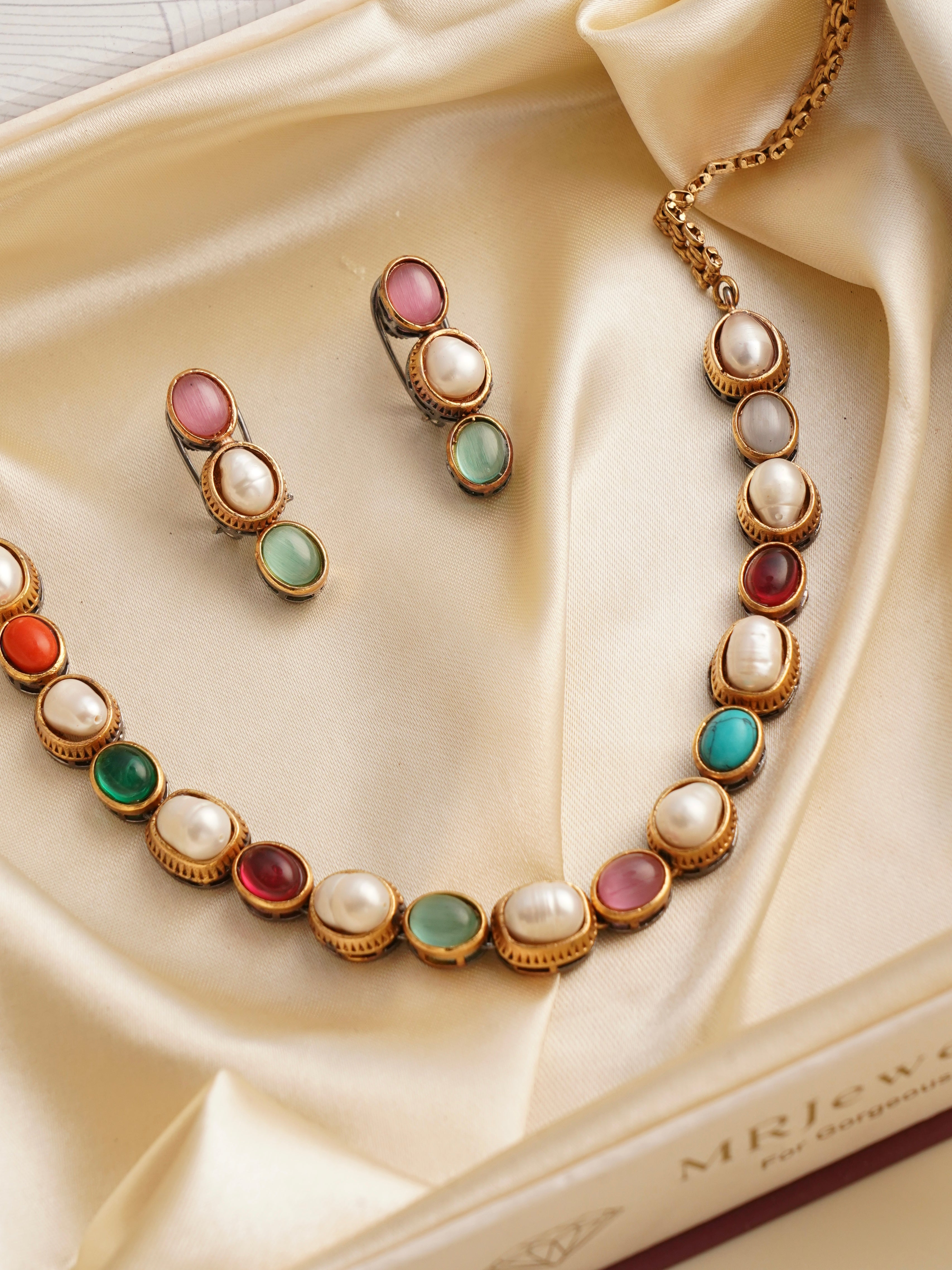 Front view of minimal luxe gemstone necklace showcasing fine beaded accents and stone arrangement