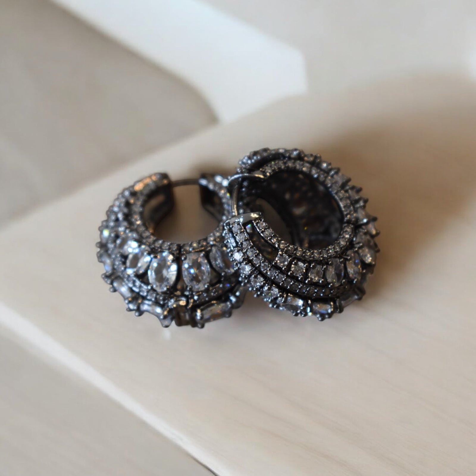 Victorian-style hoop earrings in circular design with antique finish in front view