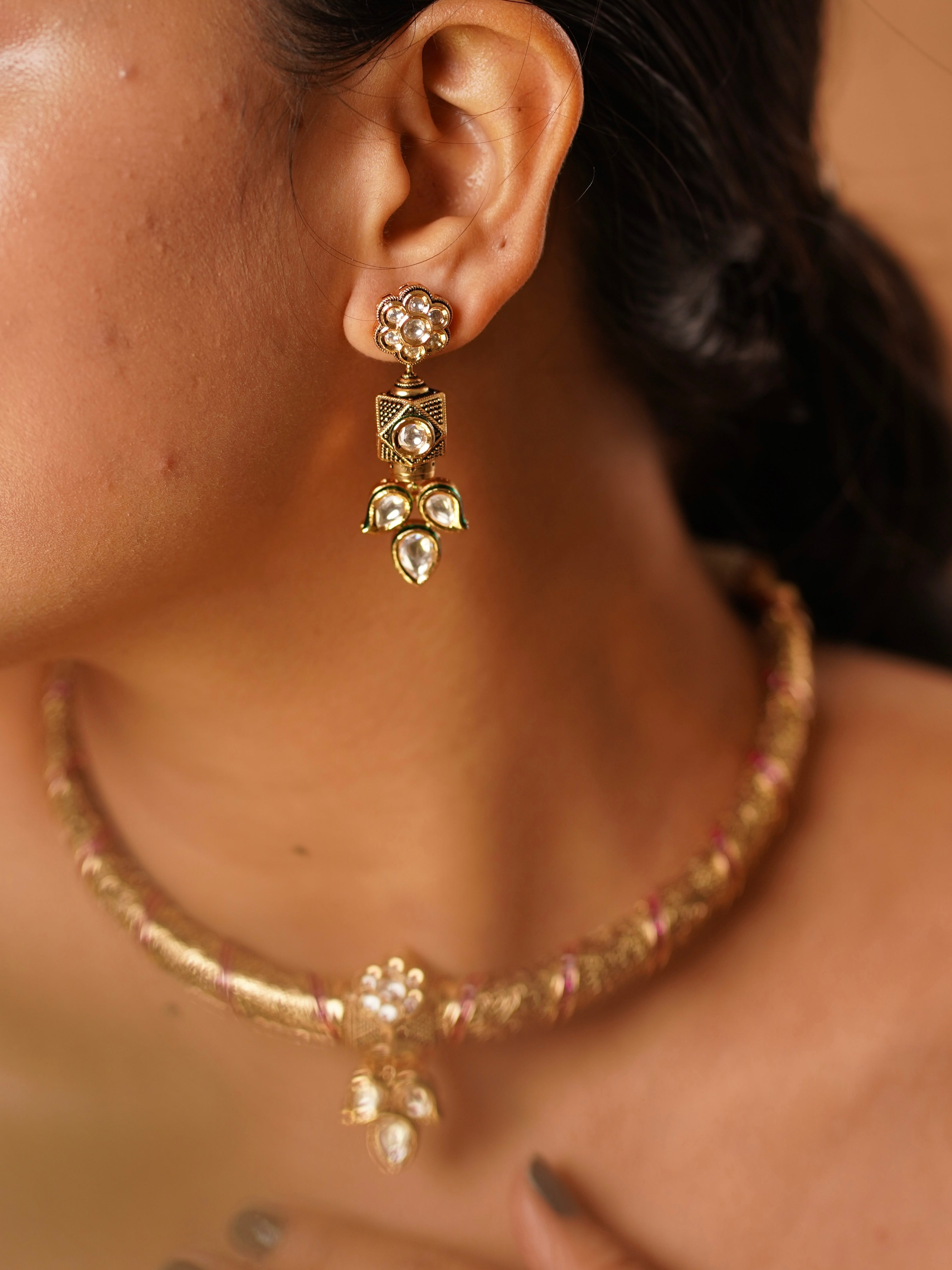 Close-up of ruby-studded hasli necklace showing vilandi craftsmanship and gold texture