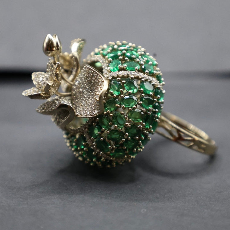 Close-up of gold-tone adjustable ring with sculpted gemstone-style cut