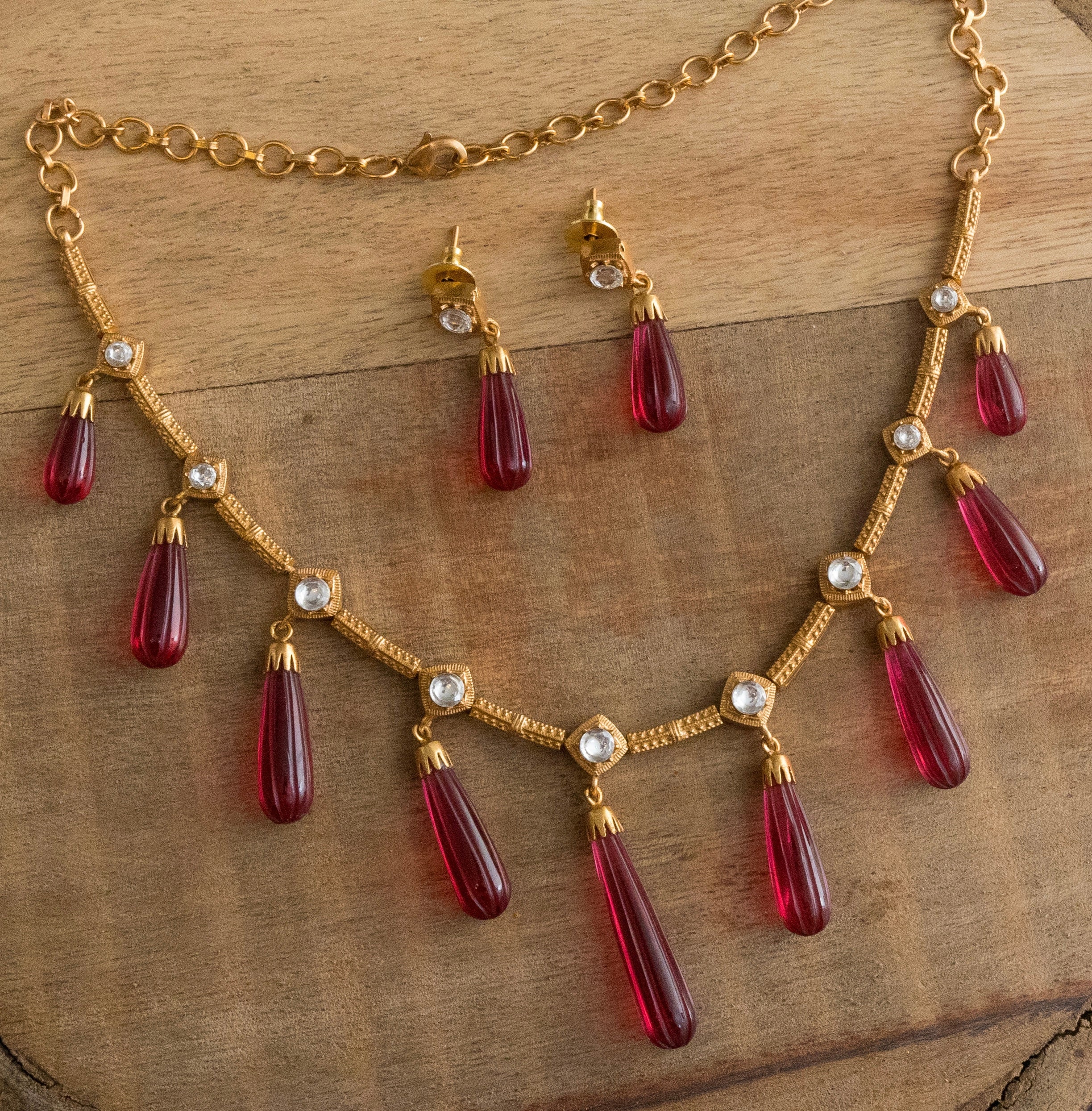 Close-up of earring design with stone detailing and gold-toned base