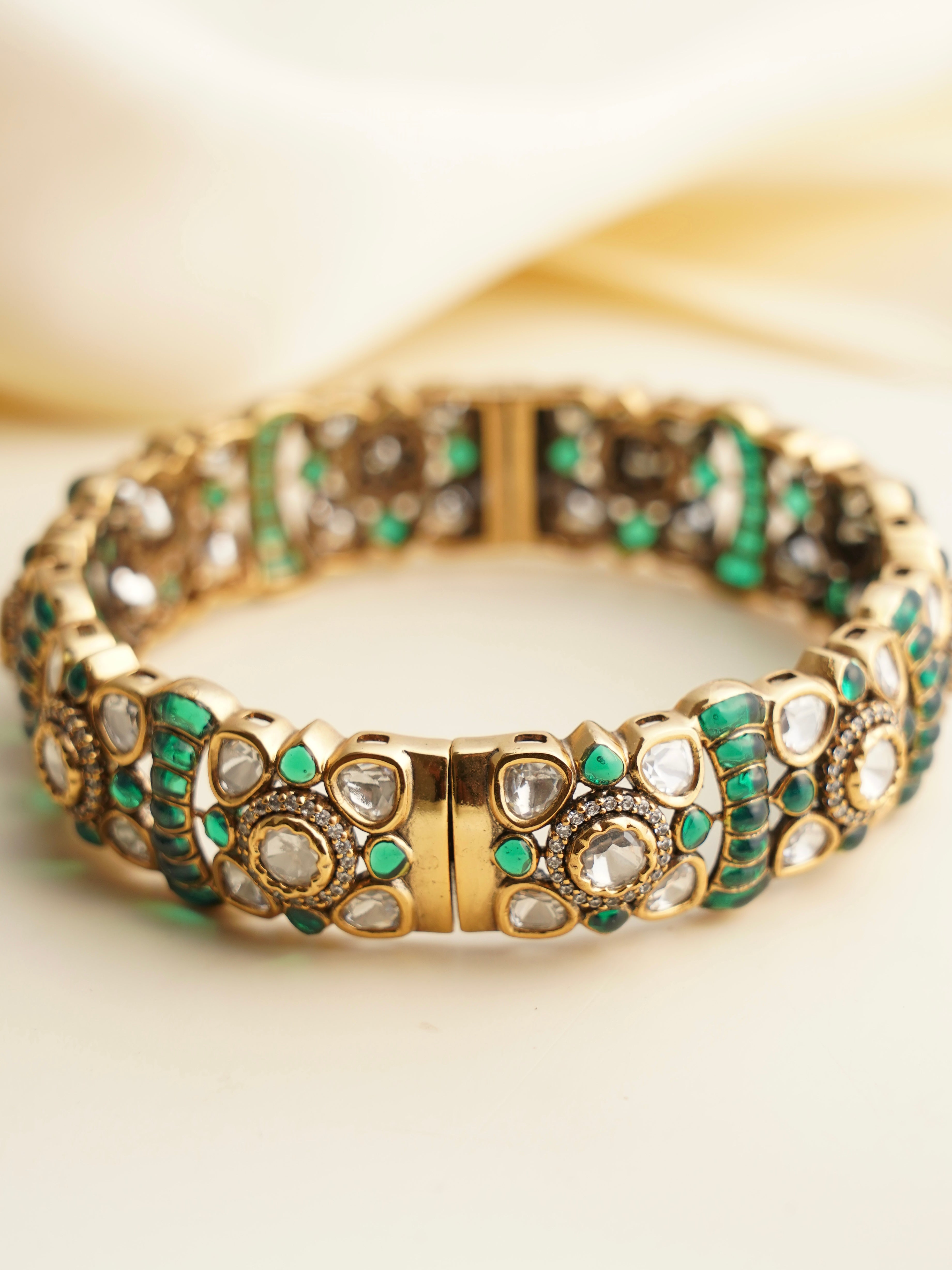 Close-up of kada clasp and kundan stonework in polished gold setting