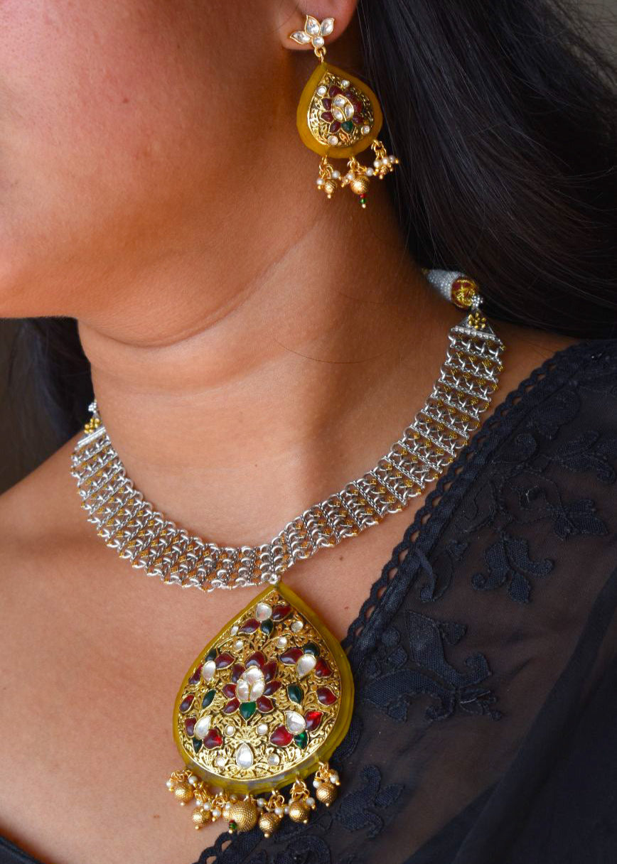 resin necklace set with red and green accents and kundan work, paired with matching earrings