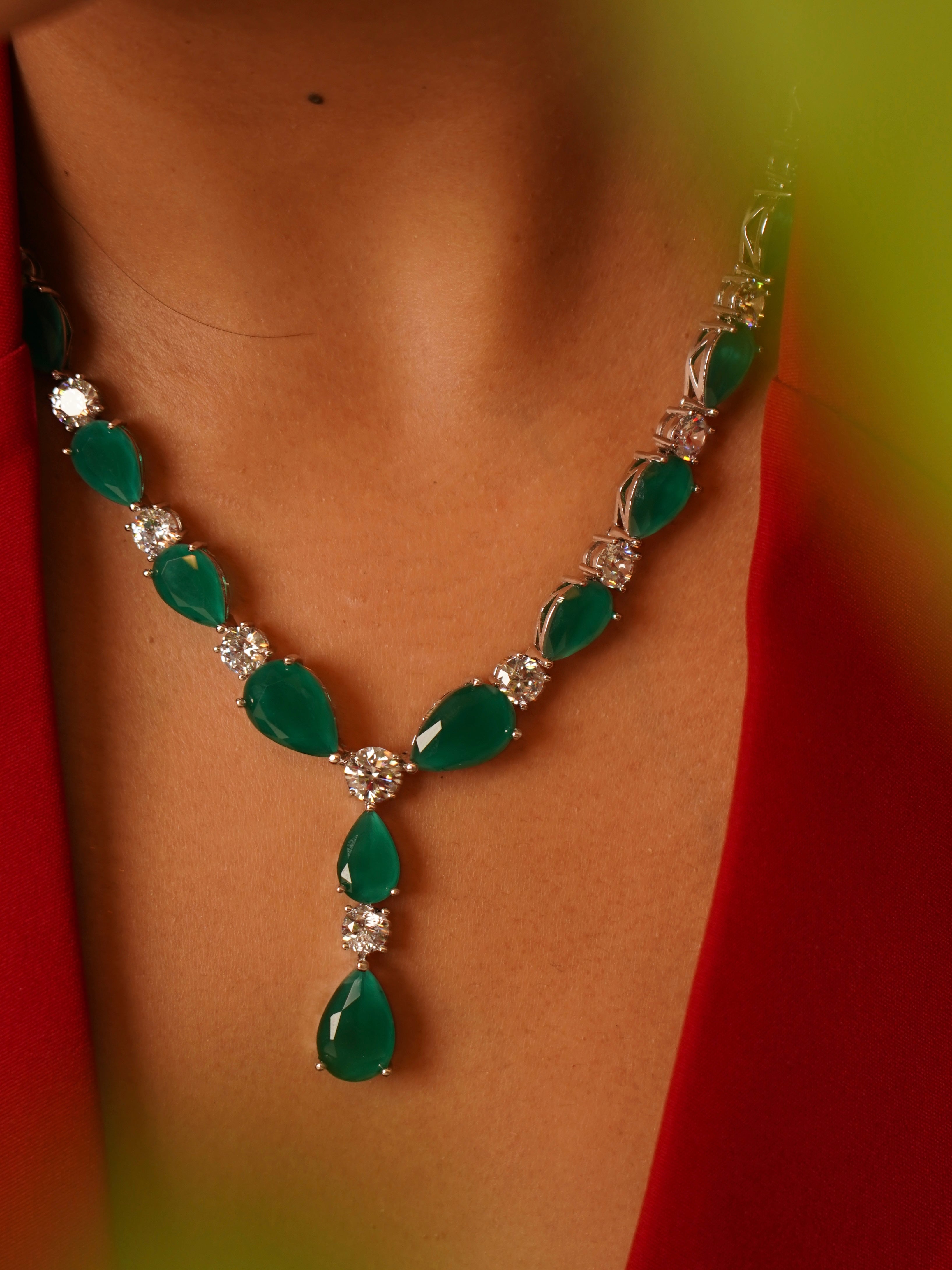 Side angle of emerald and diamond necklace with brilliant stone finish