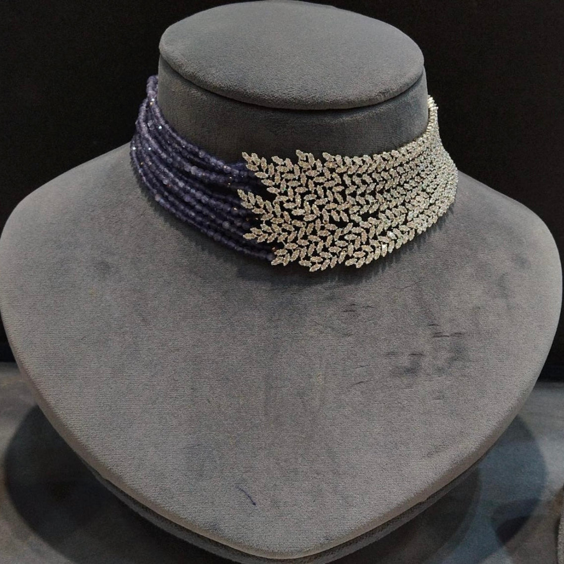 Close-up of premium CZ zircon necklace with radiant round stone clusters