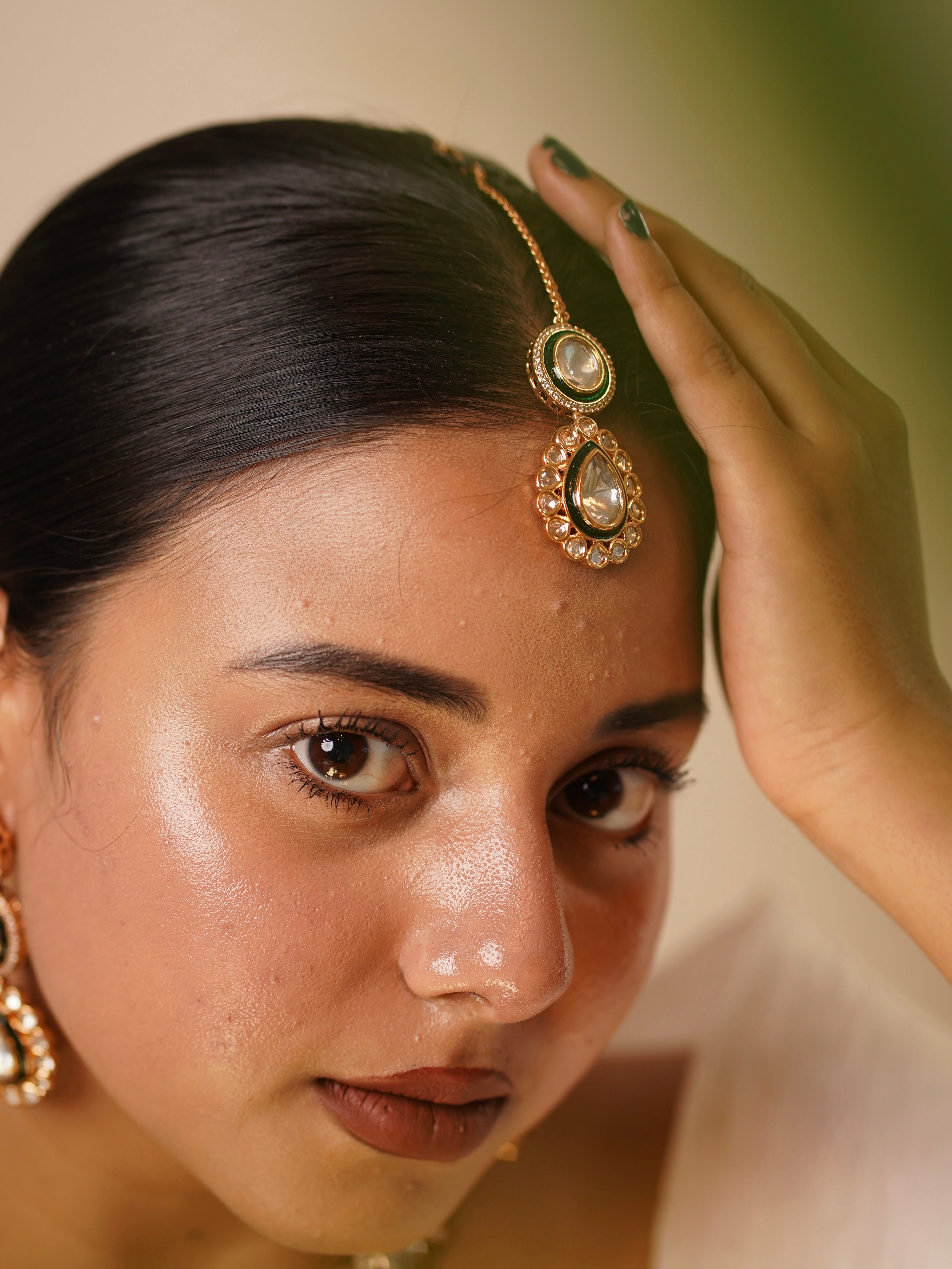 Earrings and maangtikka from polki set with delicate detailing and gold-tone finish