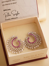 Front-facing spiral earrings encrusted with hand-set zircon, emerald, ruby and sapphire baguette stones