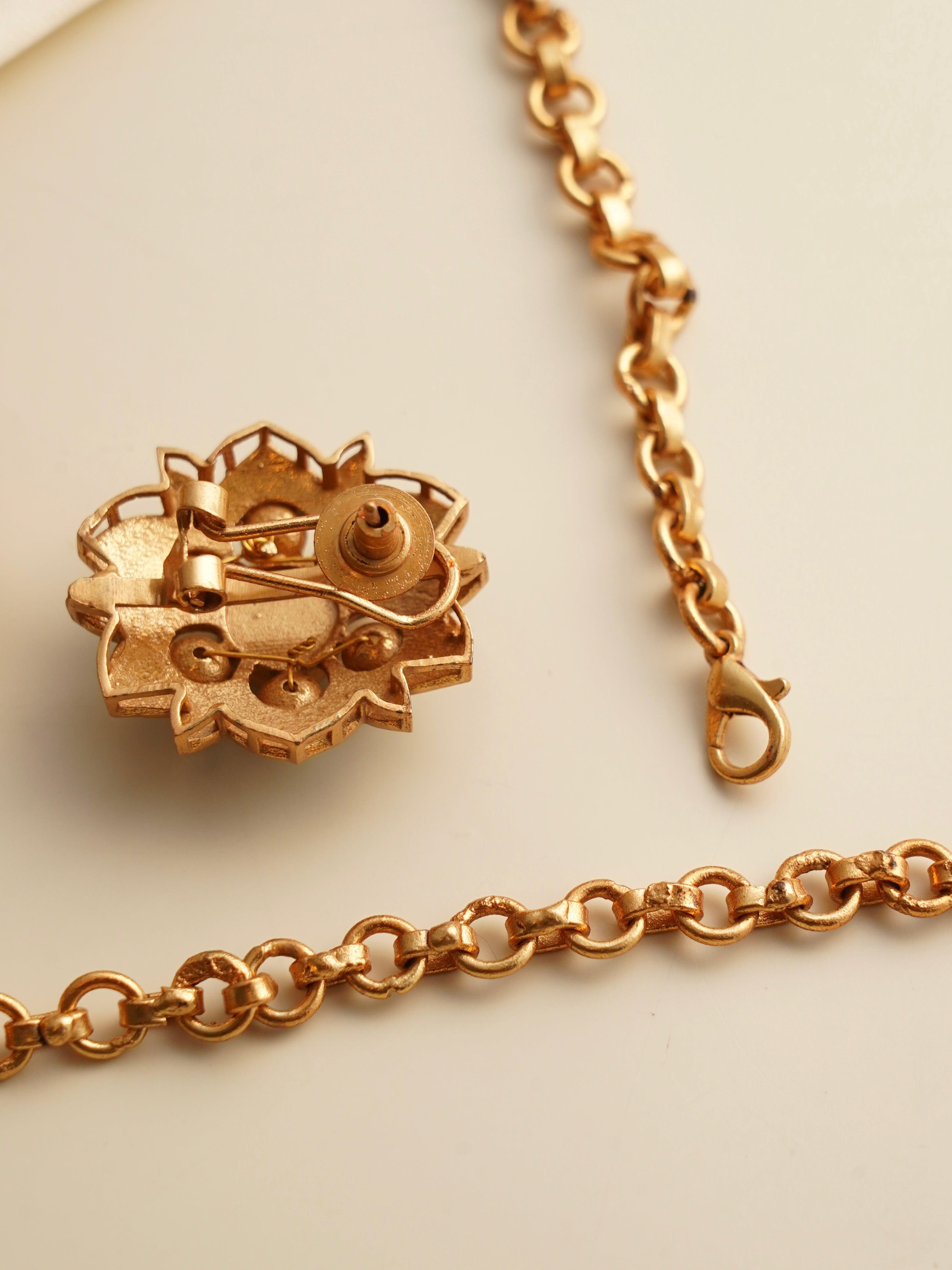 Back view of Myra Muse hasli set showing lobster clasp, textured chain and screw-back stud closure