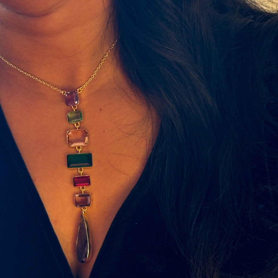 Angled image highlighting necklace layers and matching earrings in gemstone set