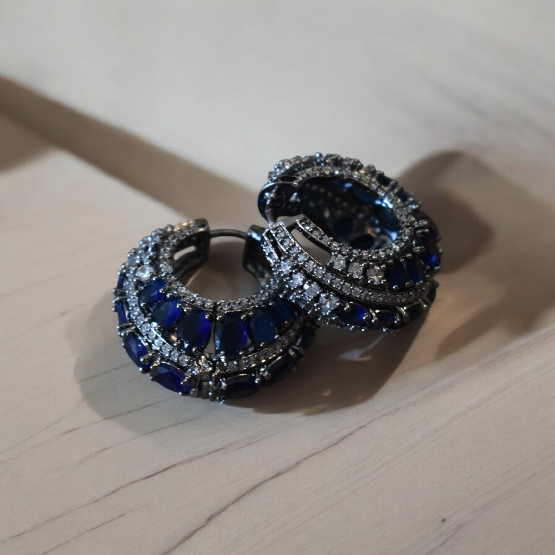 Angled view of bold victorian hoops with oxidised gold texture