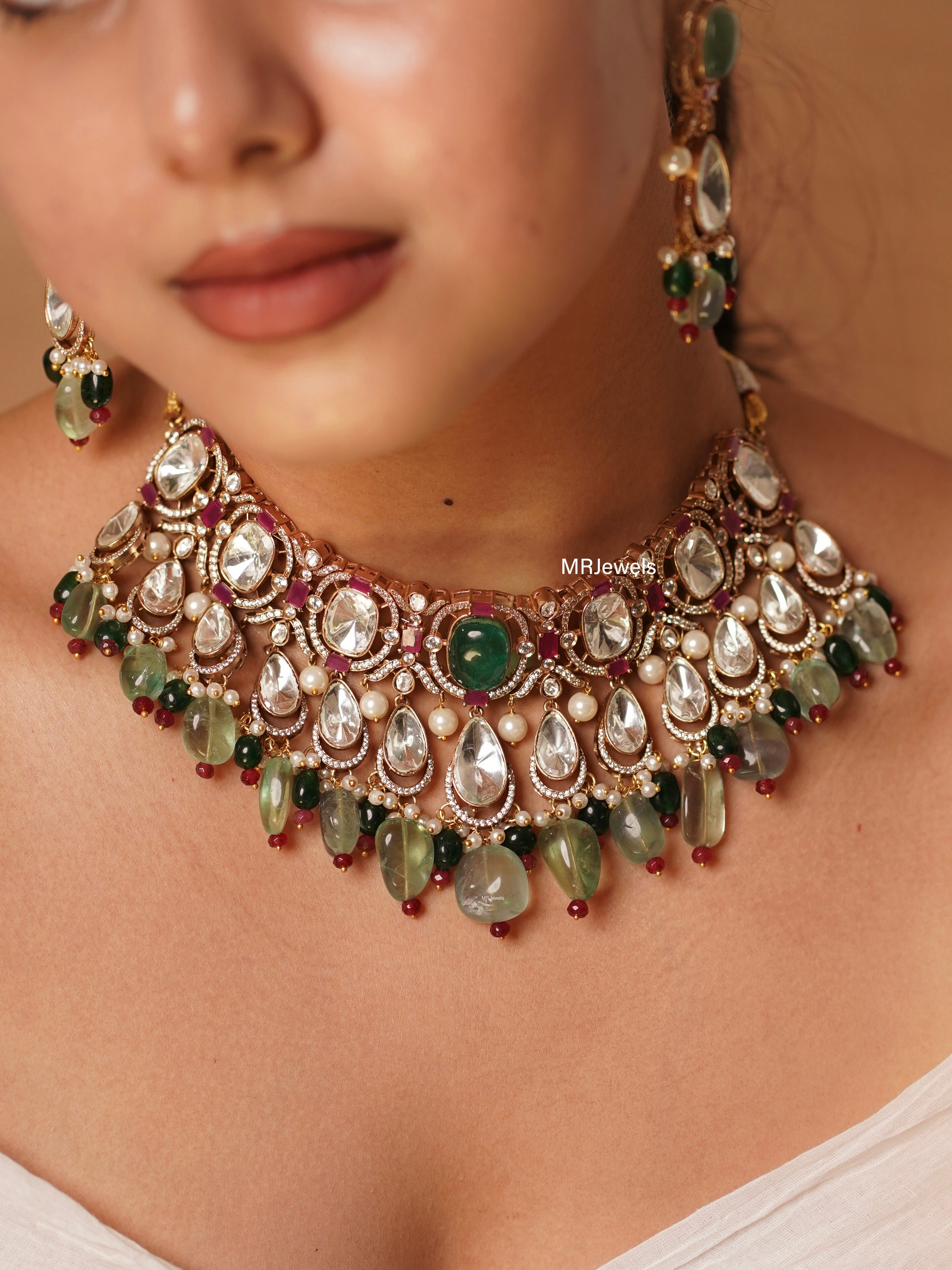 Kundan necklace set with green and ruby stones, pearl drops and traditional pendant