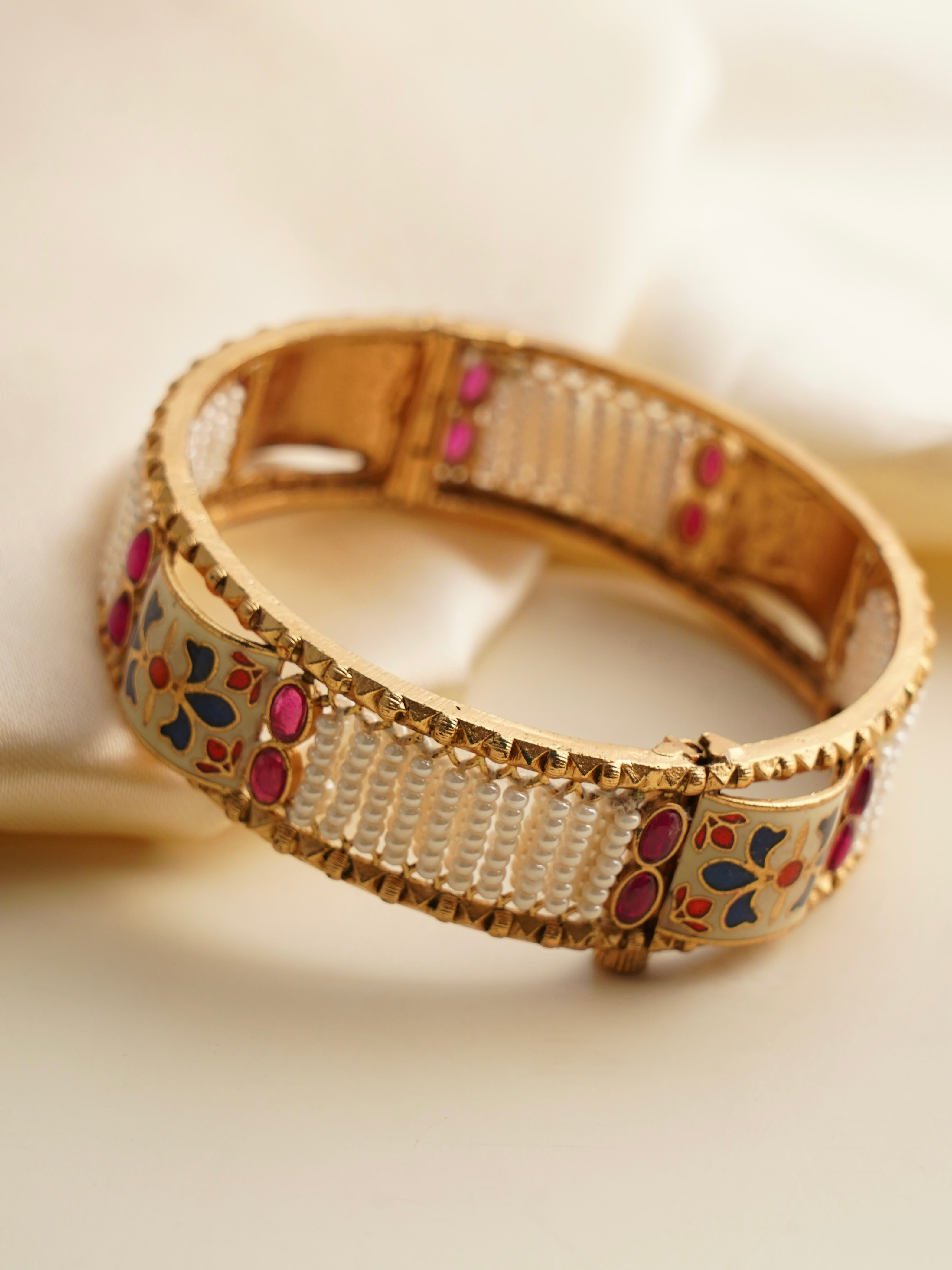 angled view of mughal-inspired enamel bridal bangles with luminous pearls
