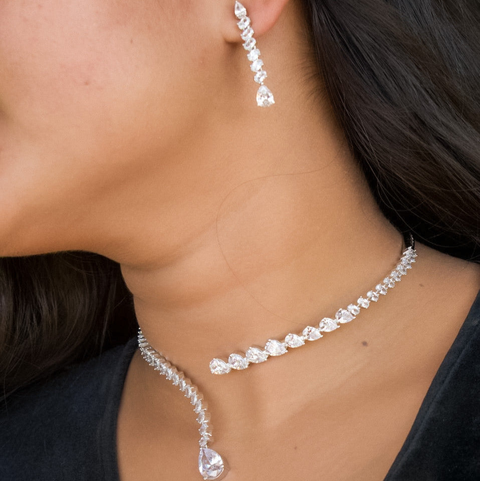 Asymmetrical diamond necklace with teardrop design and matching elegant earrings