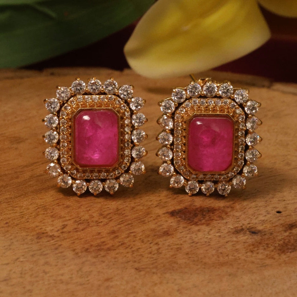 Side angle of square emerald earrings in gold plating with sparkling crystal accents