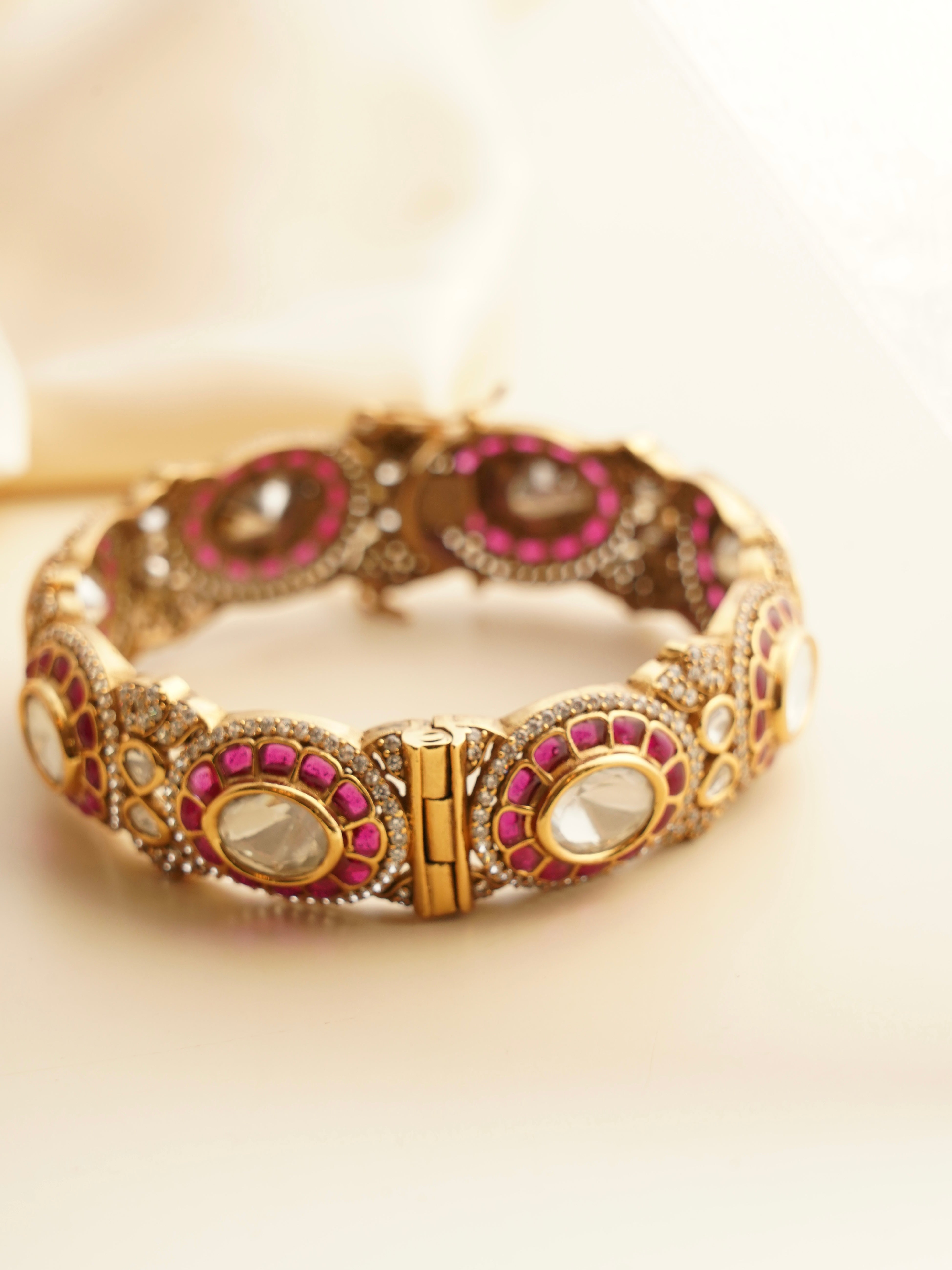Side view of ruby bangle revealing curved design and vibrant gemstone sparkle