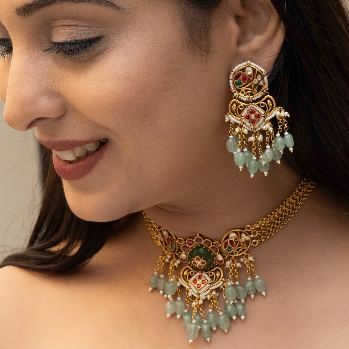 Angled shot of traditional kundan choker with dangling green accents