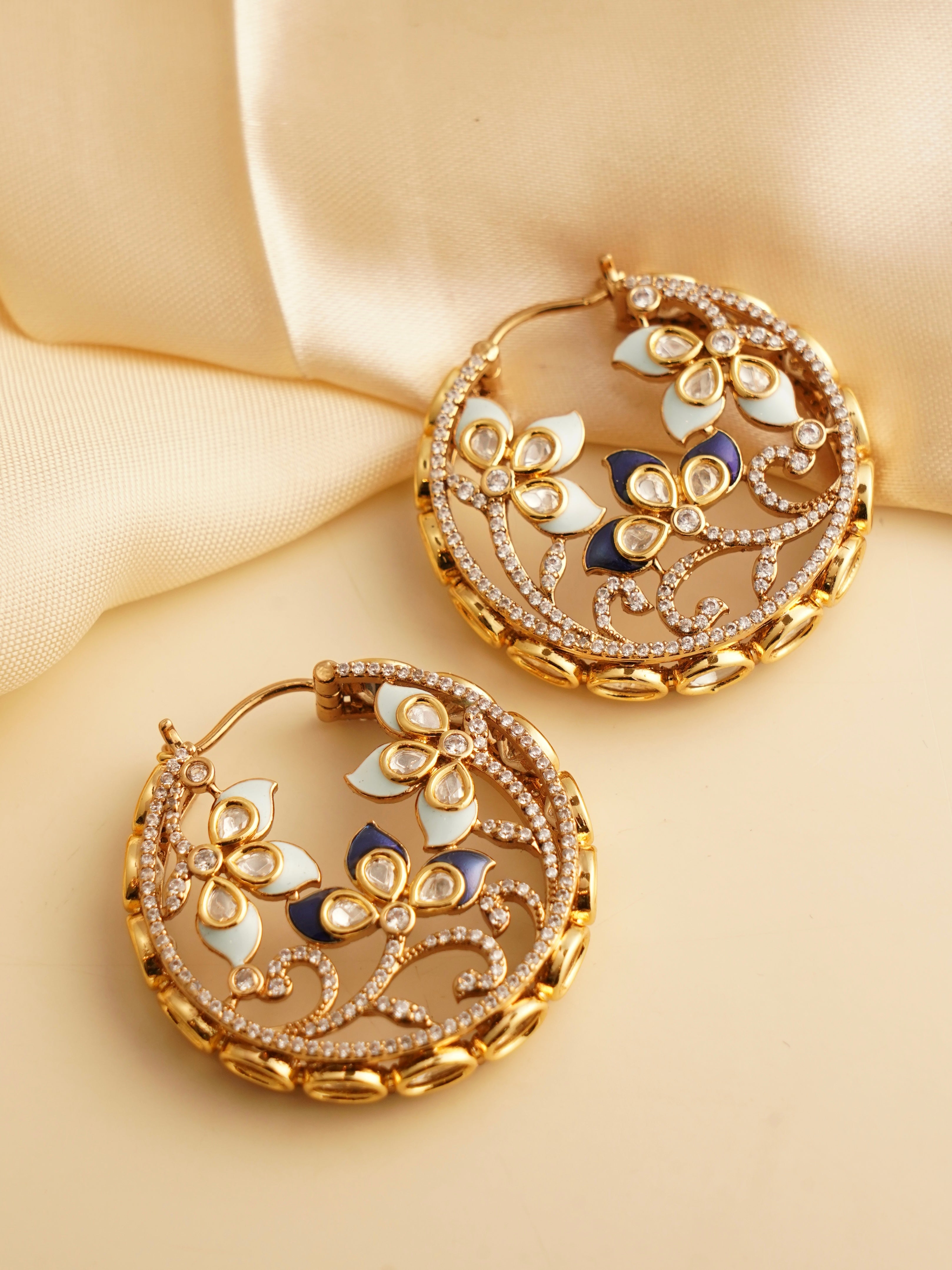 floral hoop earrings with gold finish, soft enamel hues and stone-studded petals