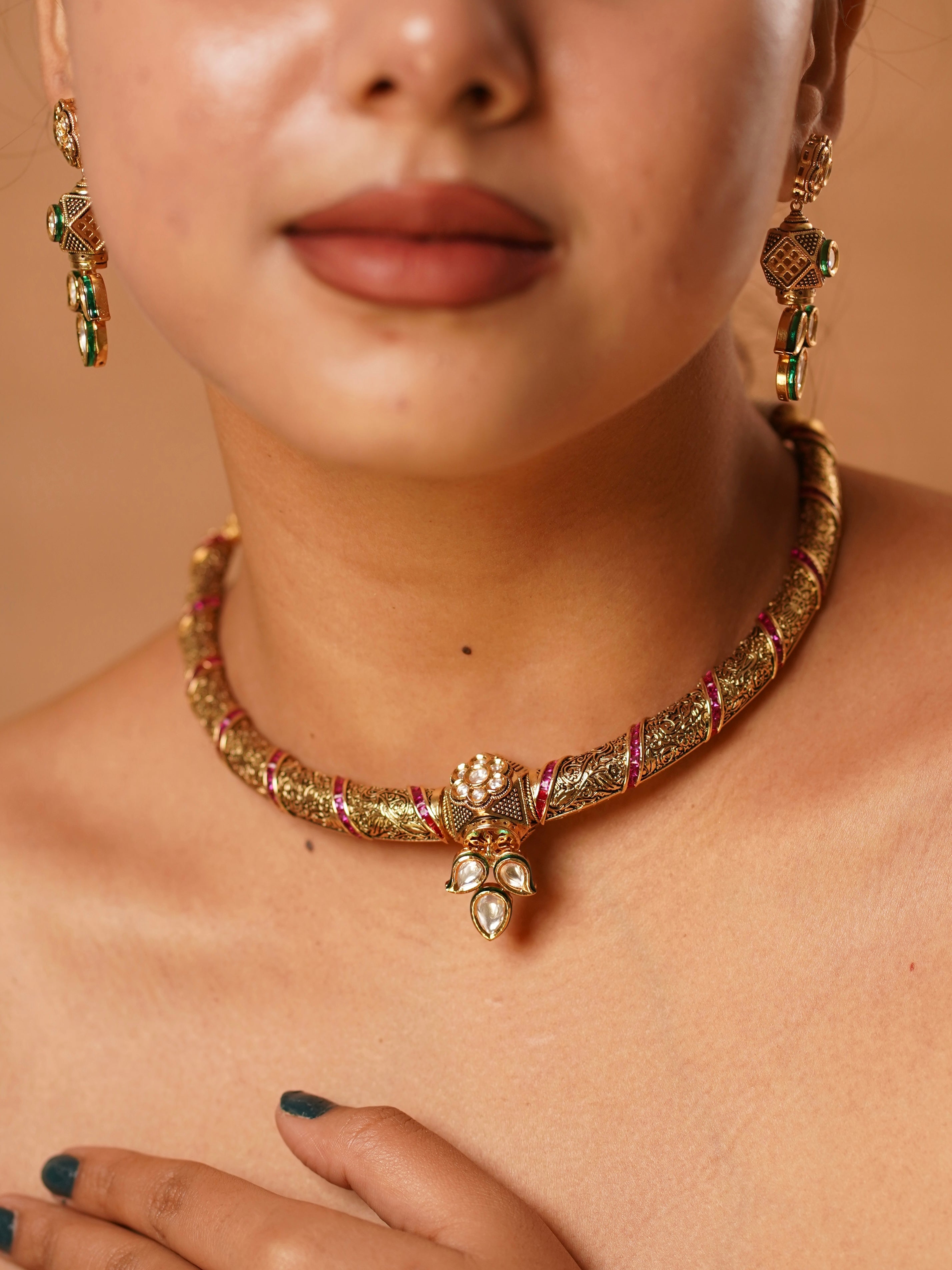 Front view of ruby vilandi hasli necklace with micron gold finish and traditional design