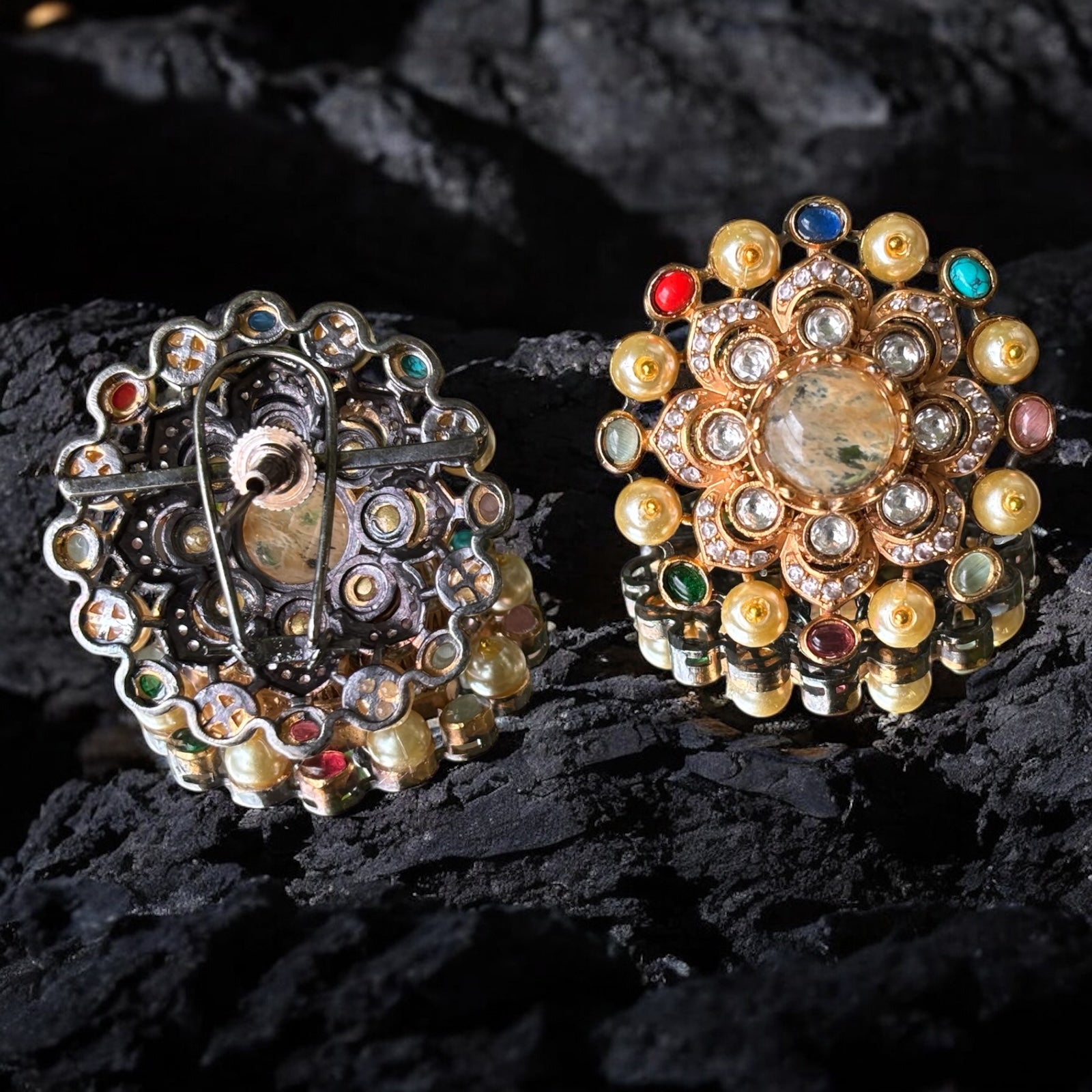 Close-up angled view of designer kundan earrings accented with pearls