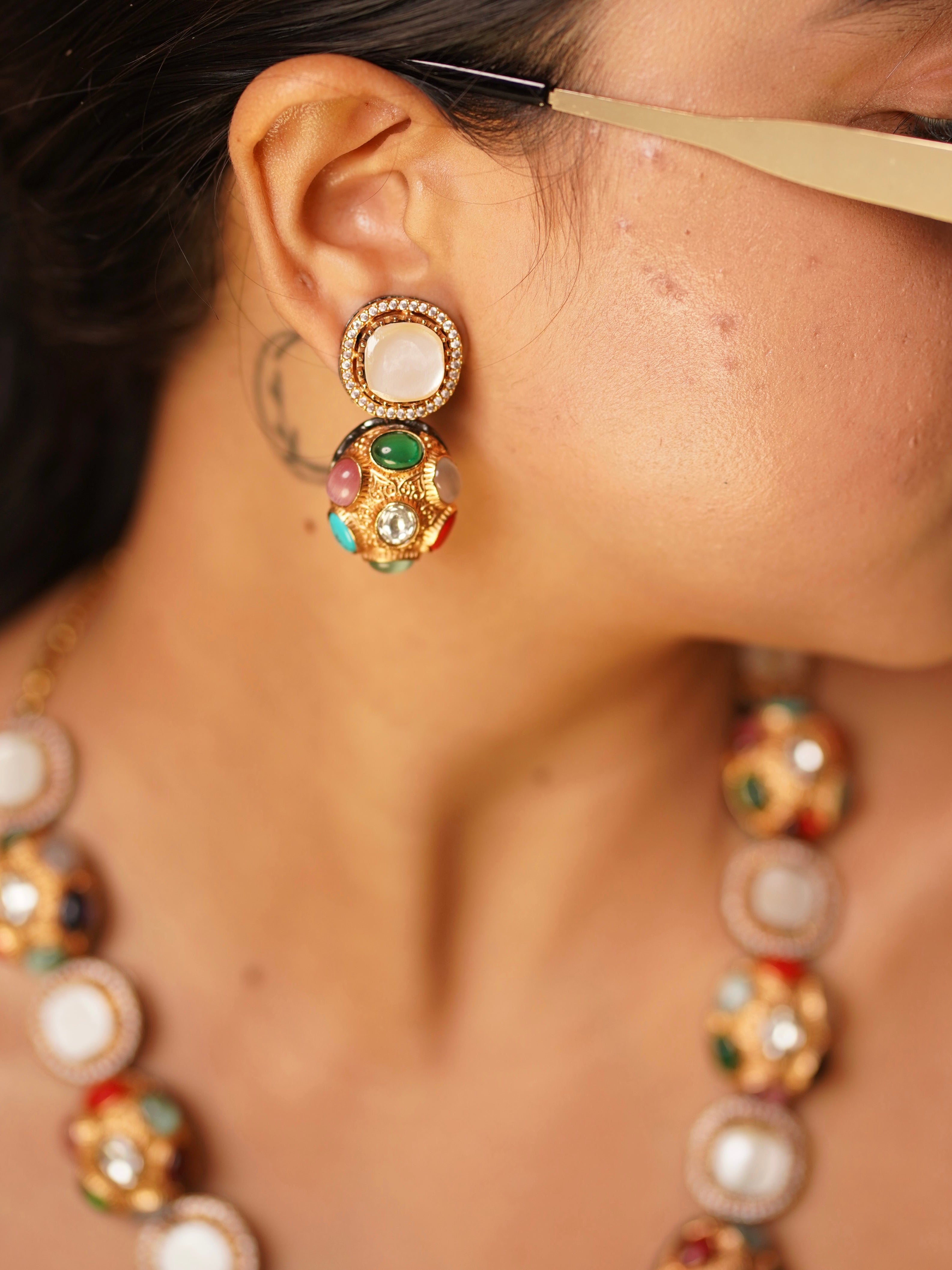 Close-up of Sabya multigem set featuring mother-of-pearl beads and bold gemstone embellishments