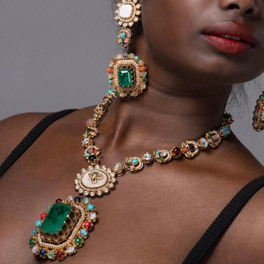 Side profile of green stone choker with royal pearl and gold accents