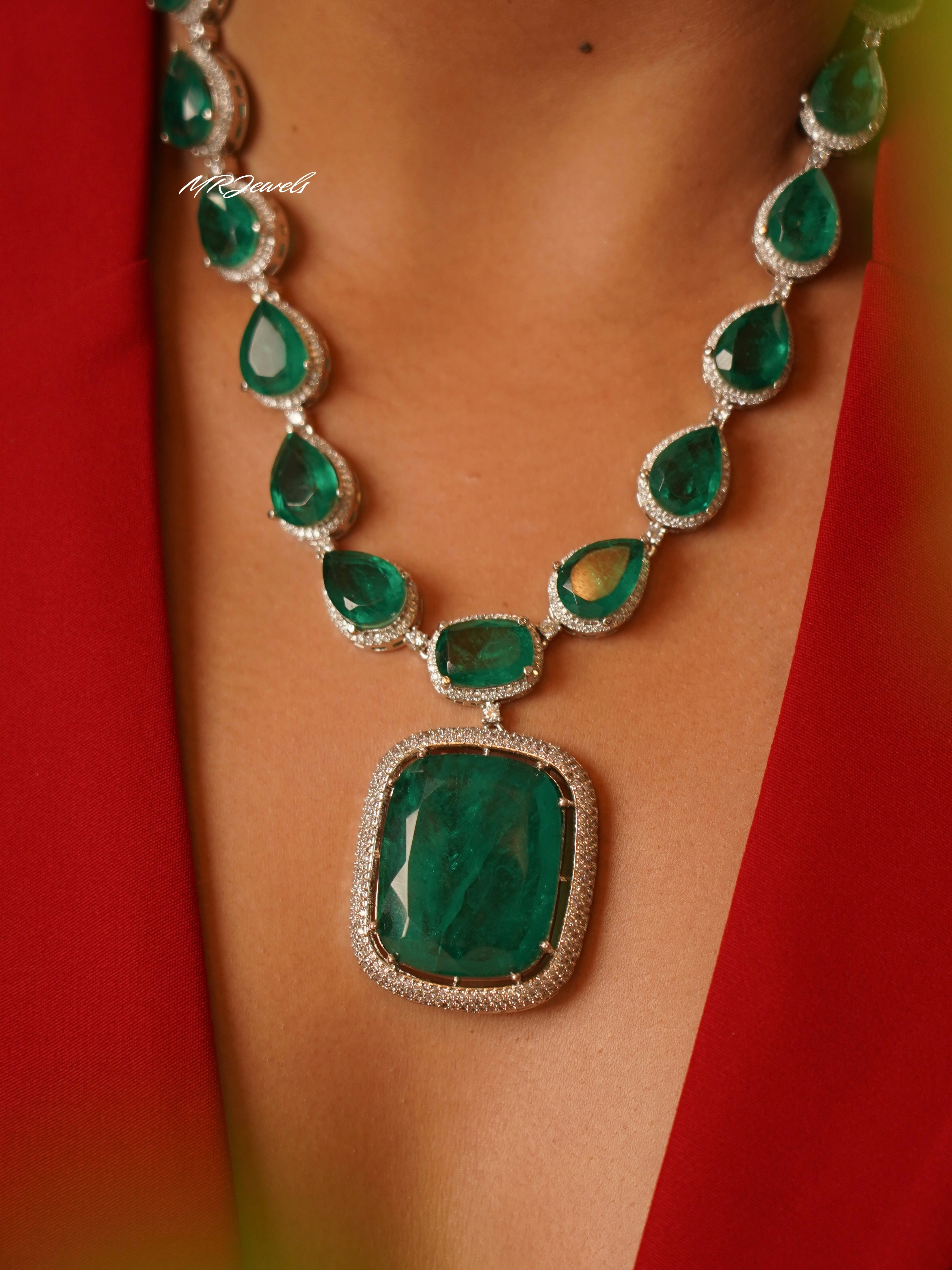 Detailed front view of emerald heirloom set with cascading teardrop stones and micro-set accents