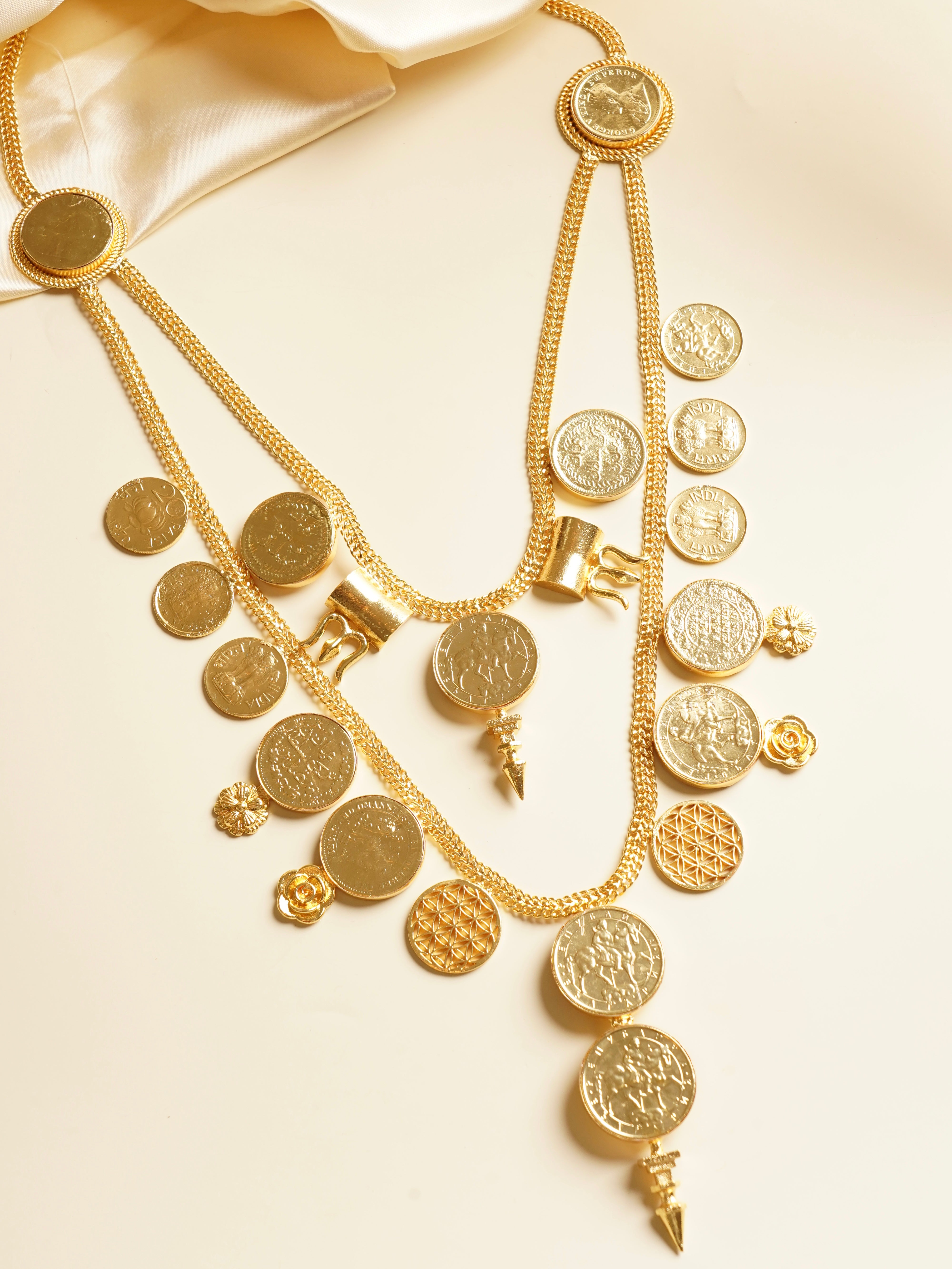 Side view of coin necklace featuring embossed medallions and vintage-inspired detailing