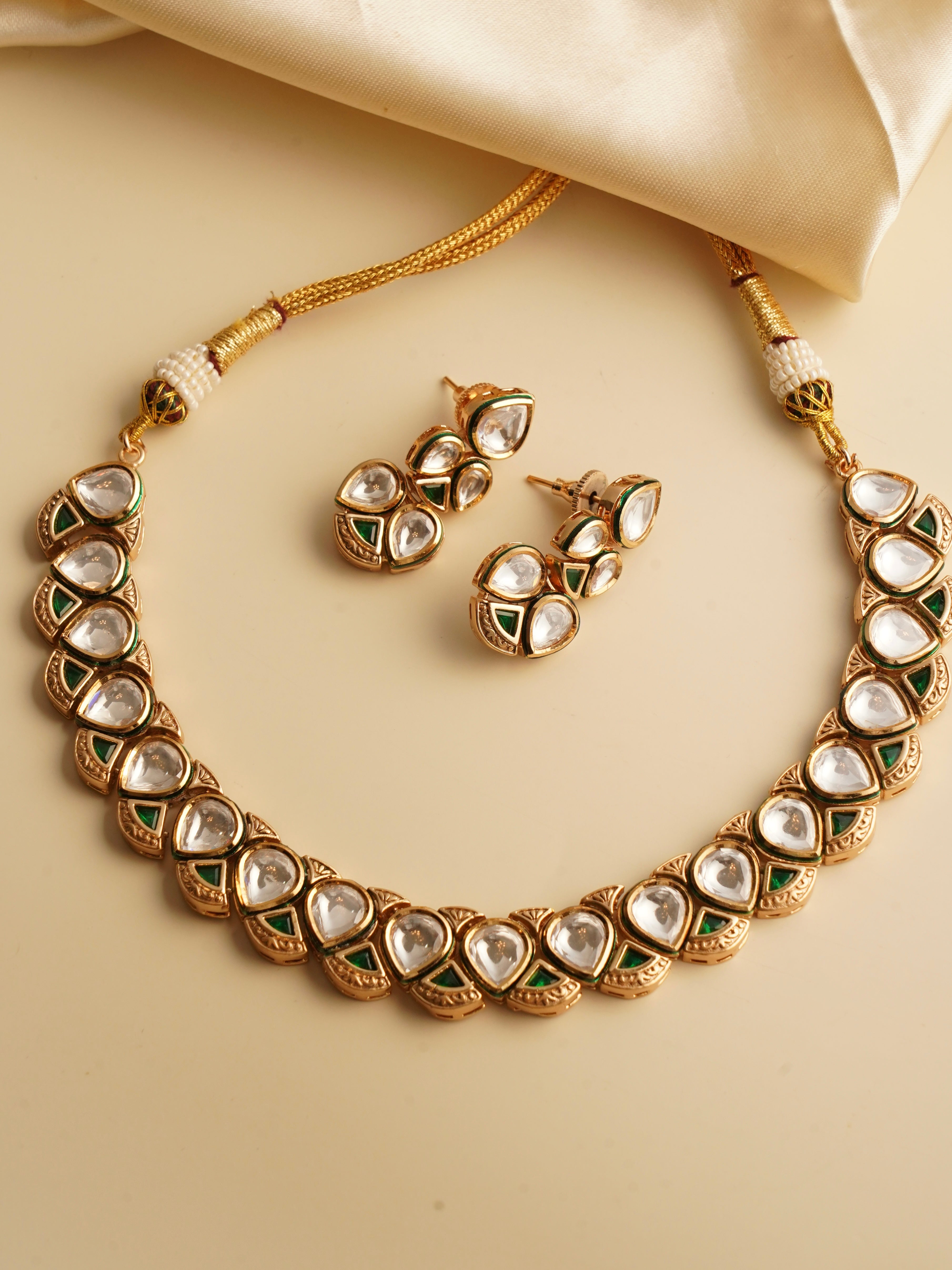 Kundan necklace set with red and green meenakari and teardrop stones on gold-plated base