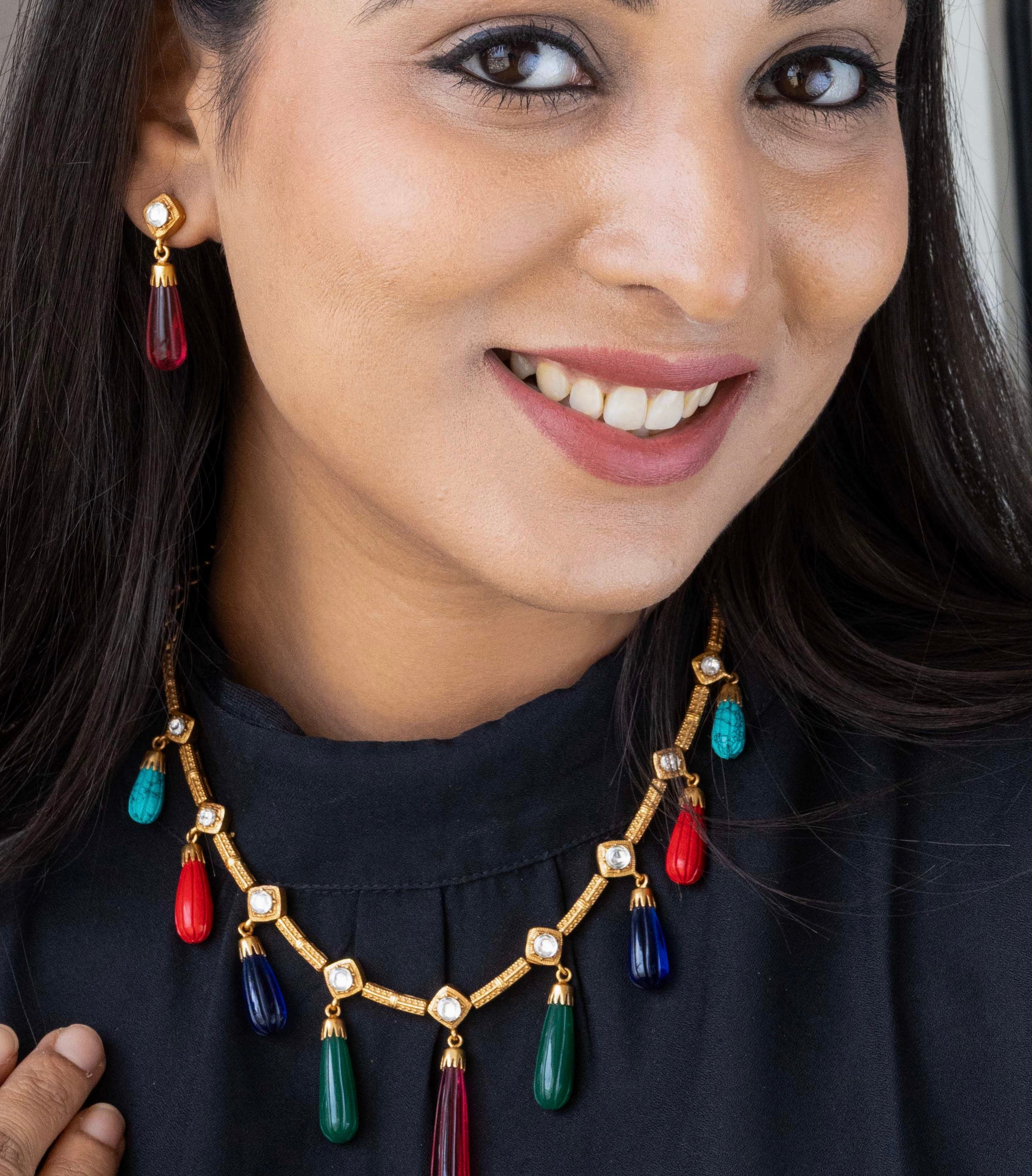 Front view of fusion necklace set with premium stones and matching drop earrings