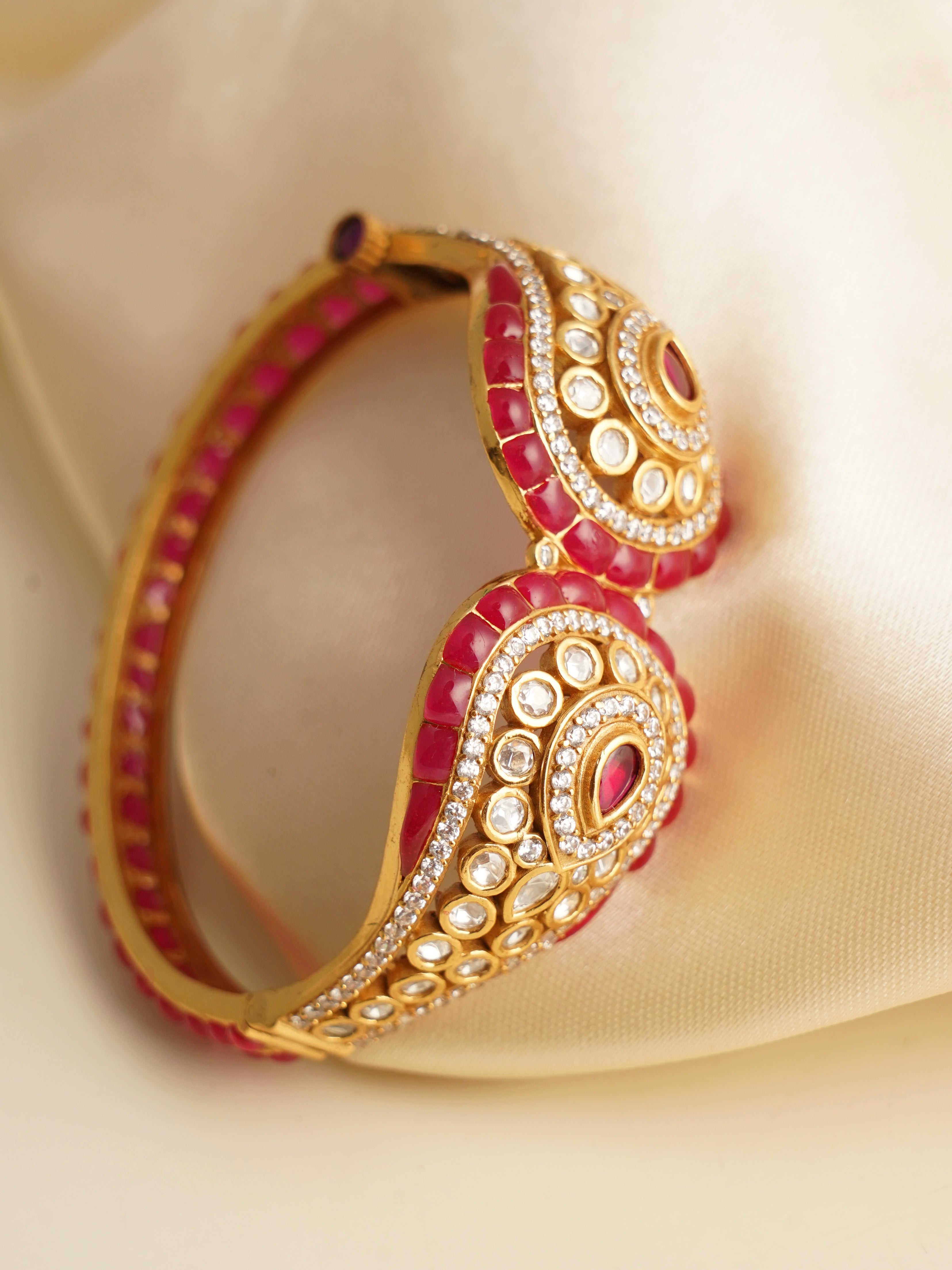 Openable kada bracelet in ruby enamel with uncut polki-style stones and bold gold finish