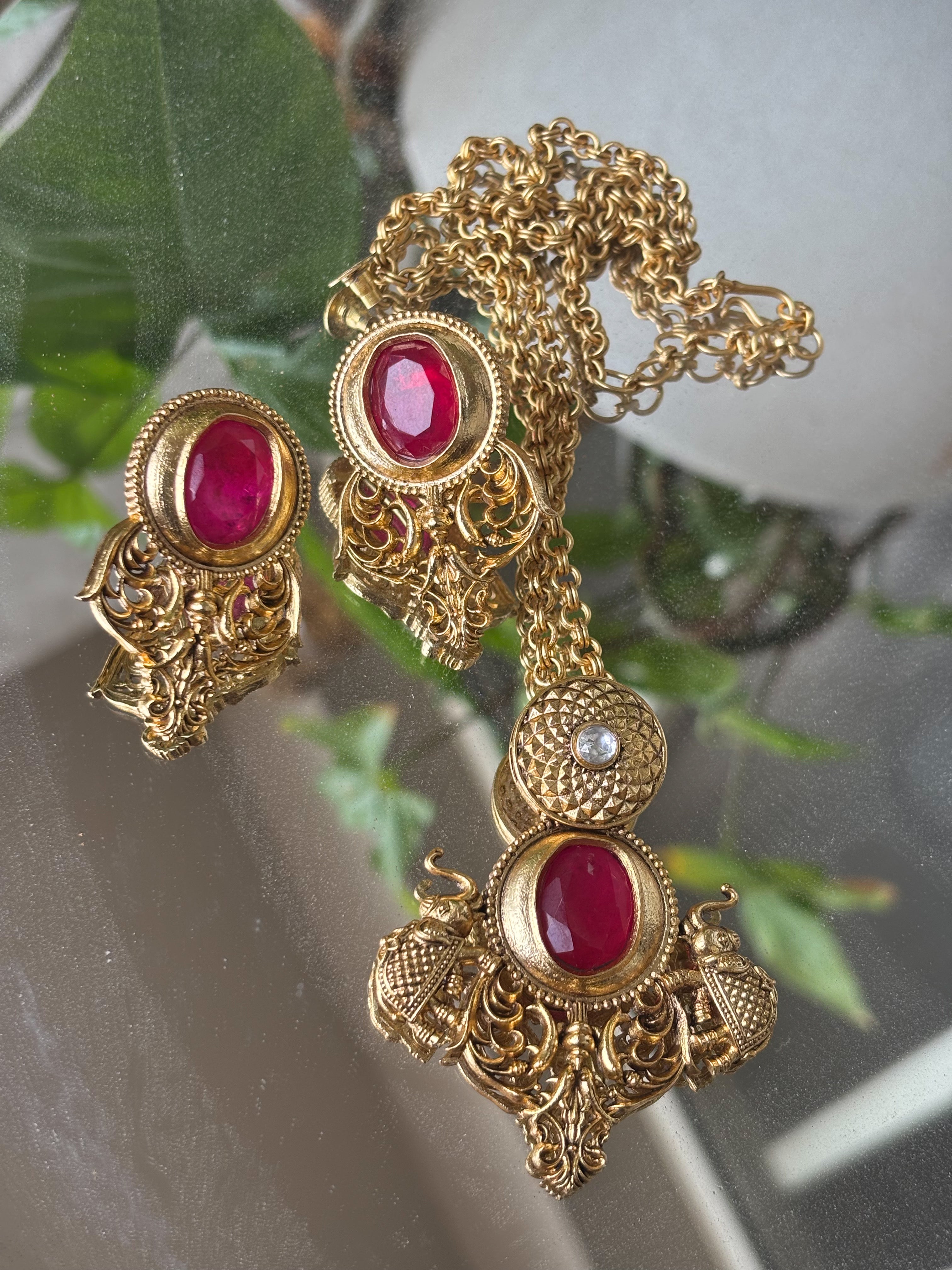 Alternate angle of traditional gemstone necklace with drop earrings and engraved pendant