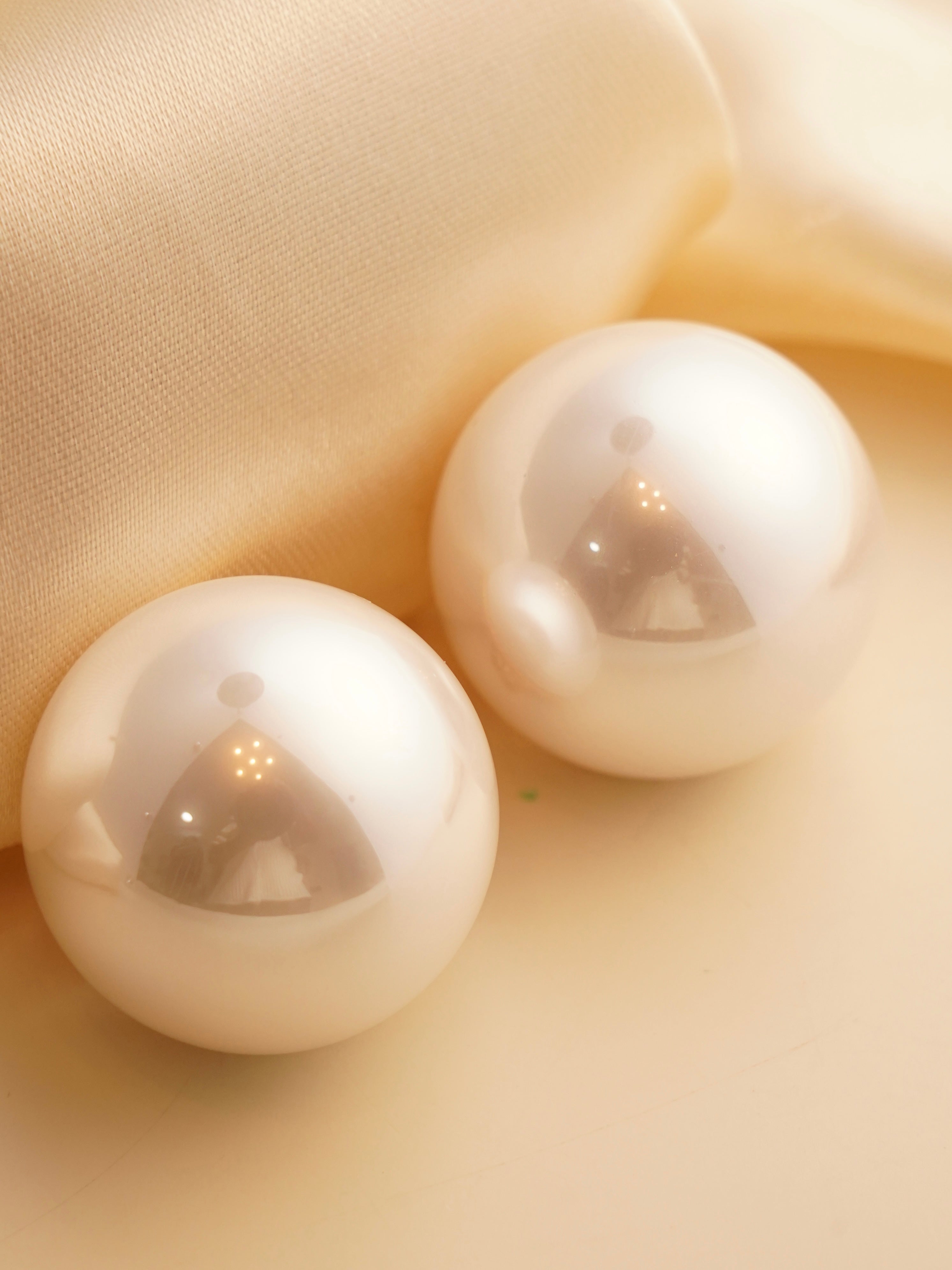 Rear view of oversized pearl studs with secure post backing and polished setting
