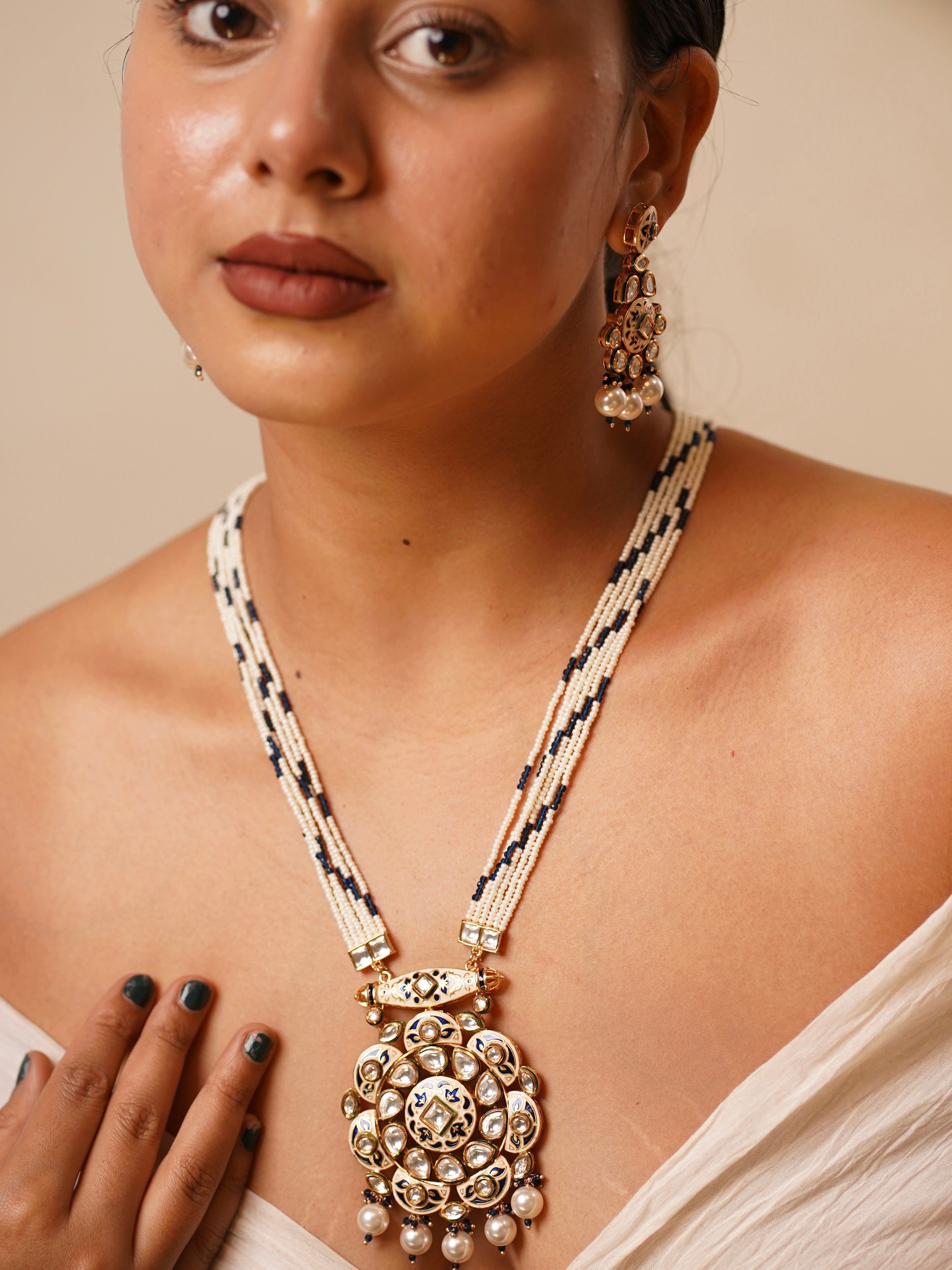 Long kundan pearl haar necklace with oversized pendant, blue meenakari, and ivory-navy beads